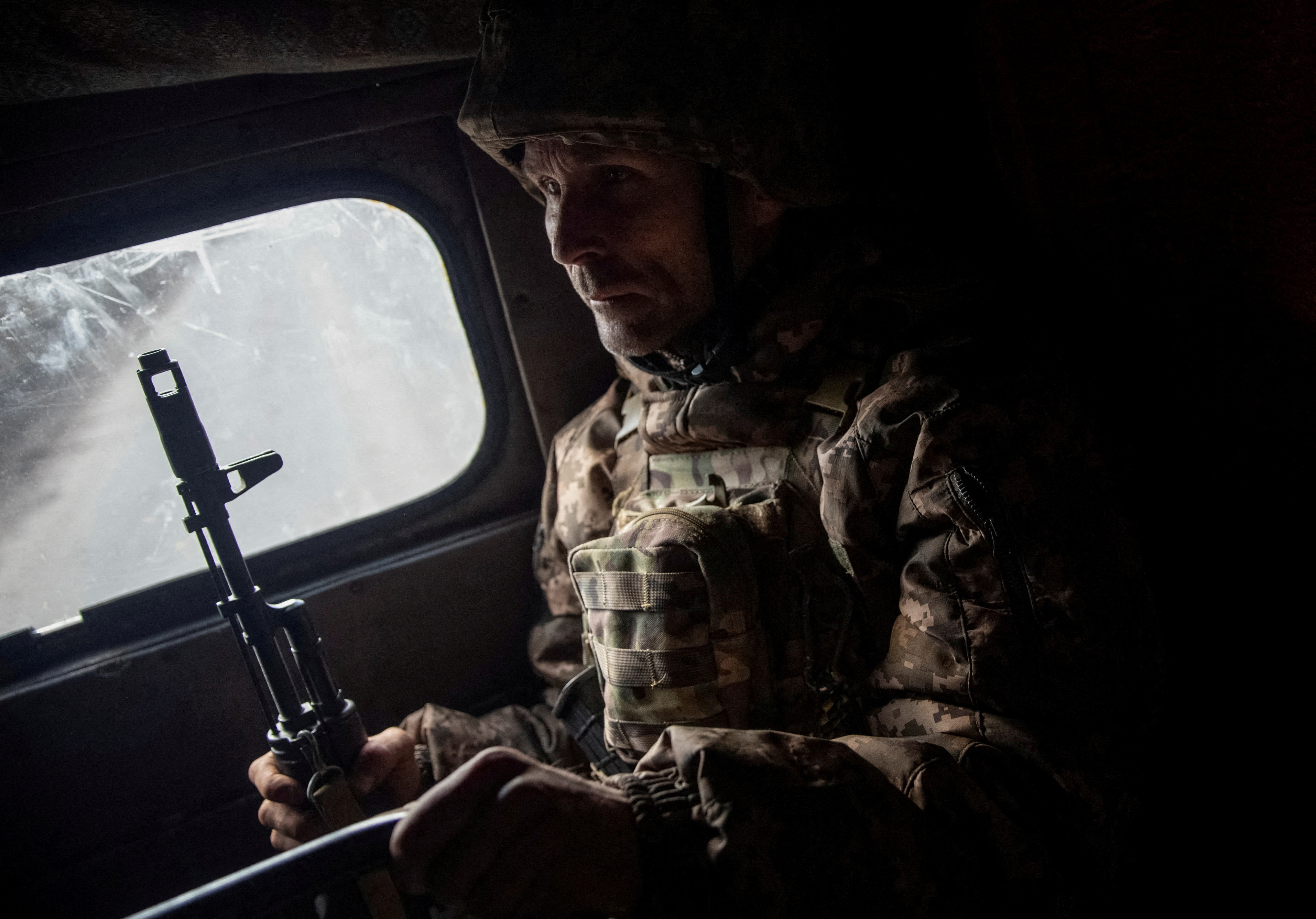A Ukrainian service member rides a military vehicle in Bakhmut