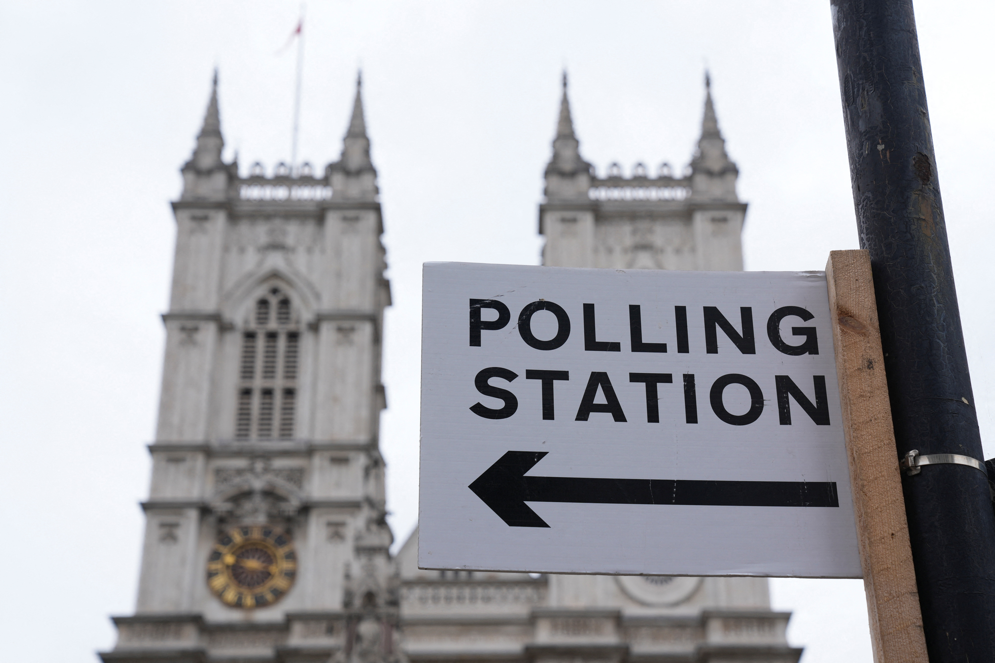 Polling station direction sign is seen ahead of general elections 