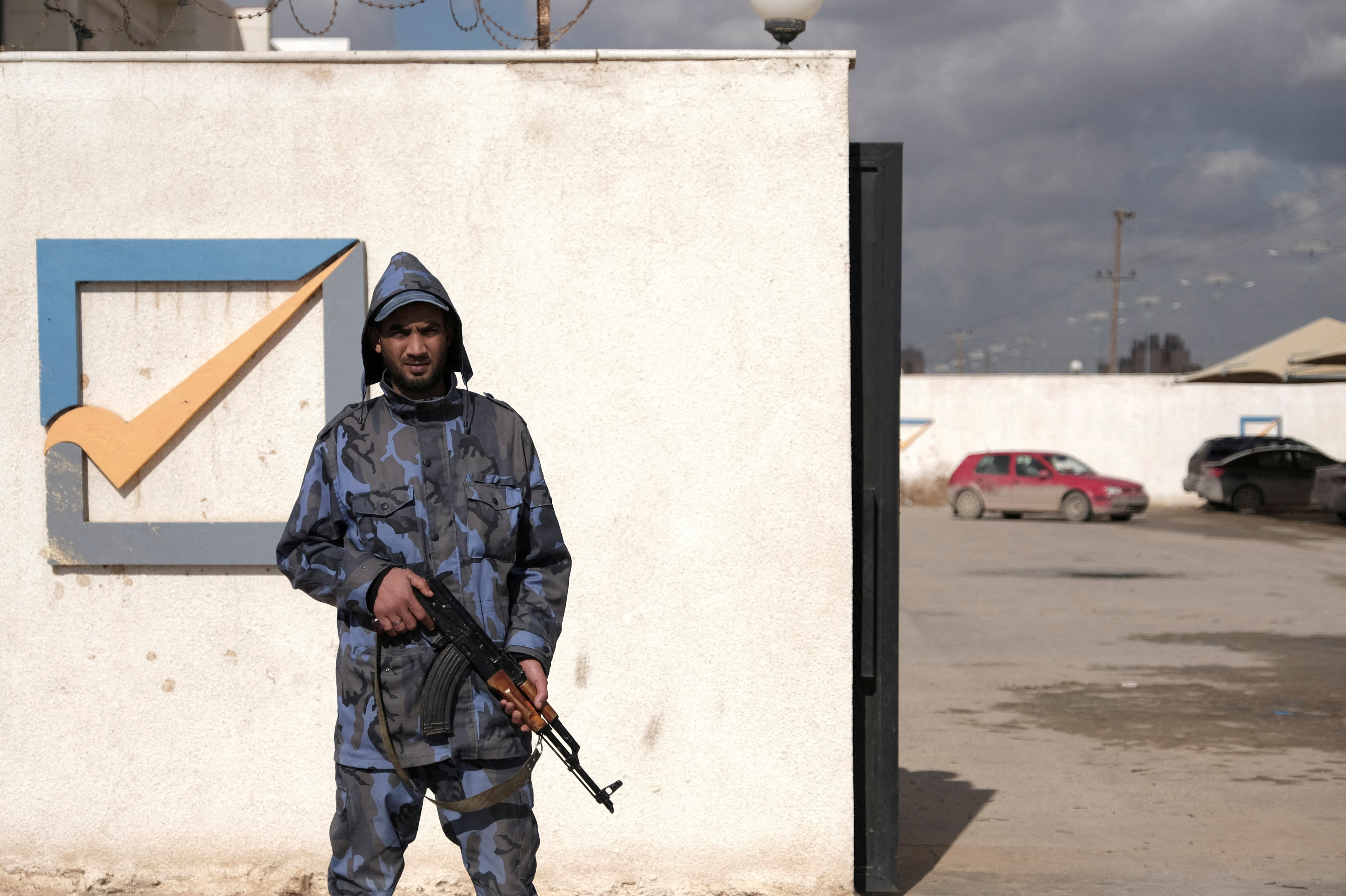 A security officer stands in front of the High National Election Commission building in Benghazi