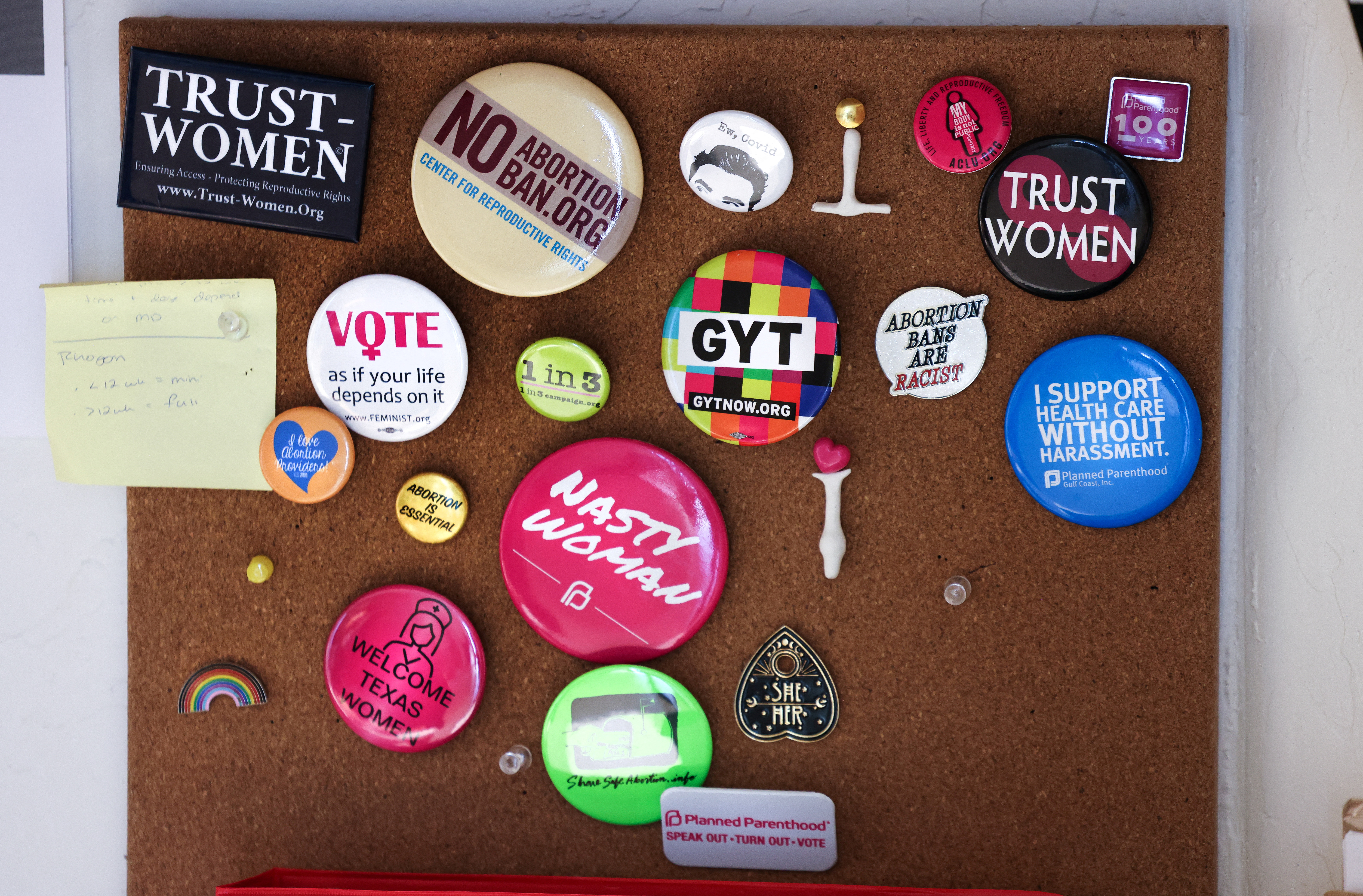 Feminist and reproductive freedom buttons decorate a work space in the Trust Women clinic in Oklahoma City, Oklahoma, U.S., December 6, 2021. REUTERS/Evelyn Hockstein