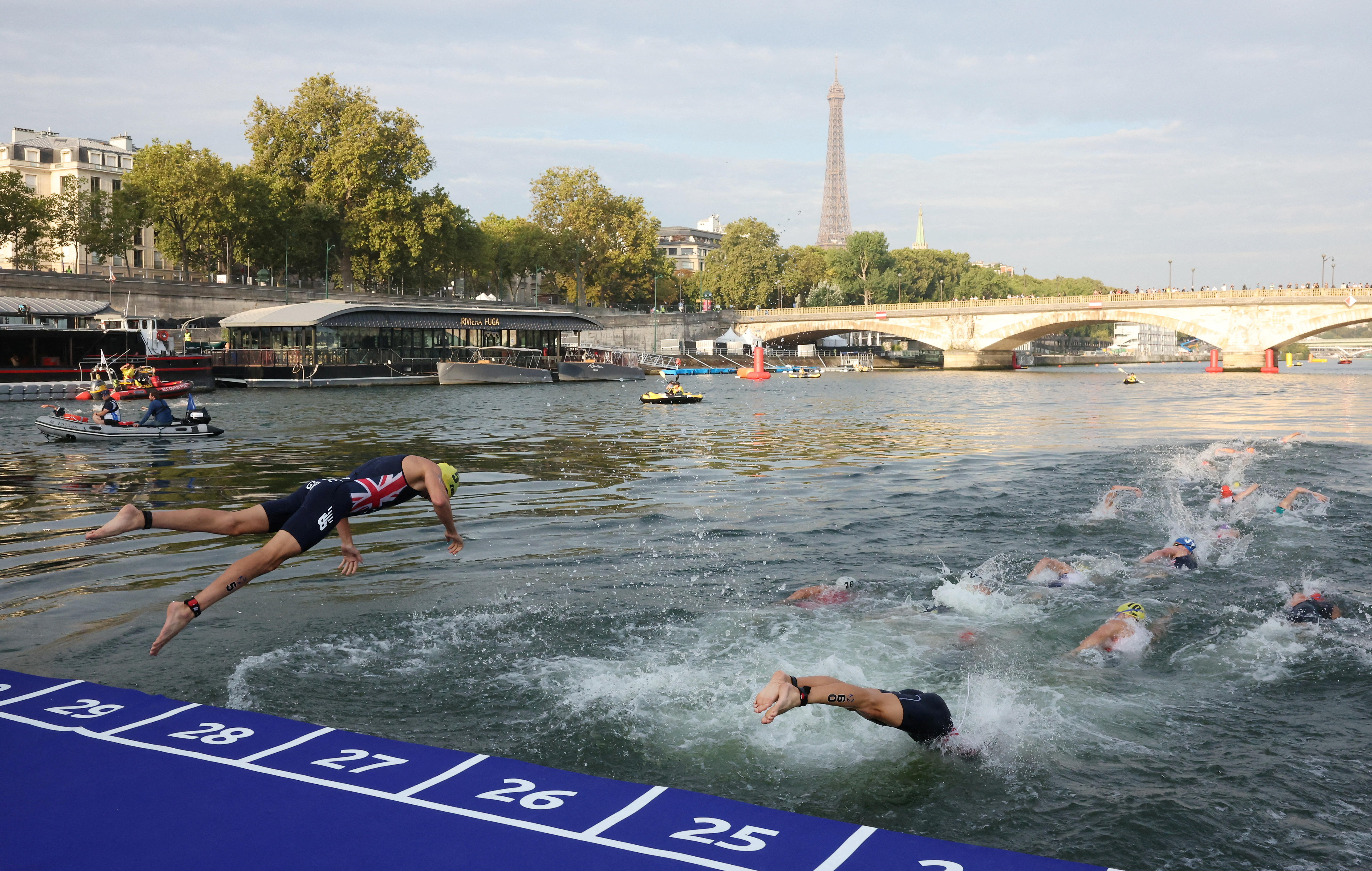 Triathlon swimming training session cancelled as rain lifts Seine pollution  levels | Reuters