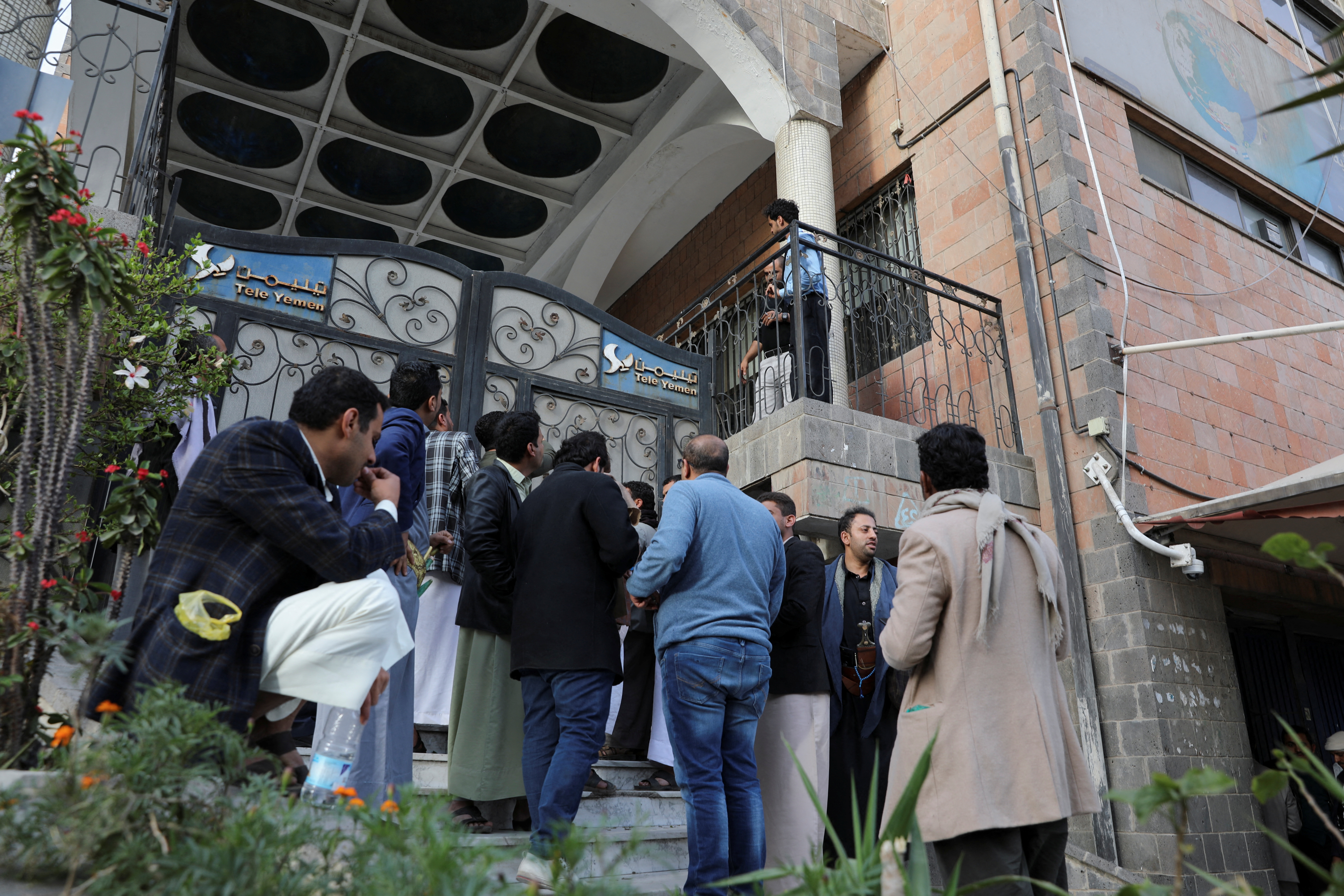 People wait outside TeleYemen company to get satellite internet connection amid an outage of internet service in Sanaa