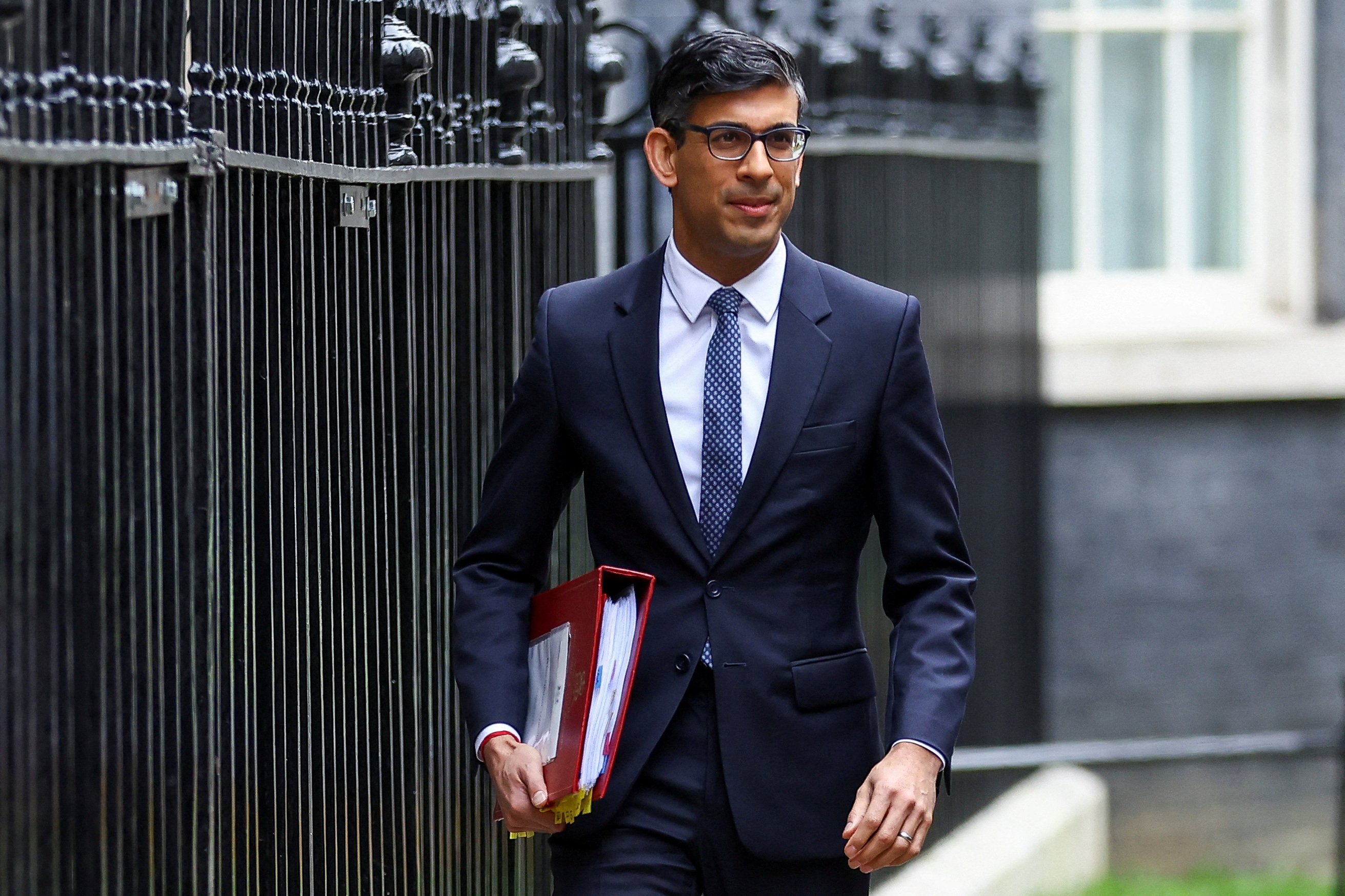 British Prime Minister Rishi Sunak walks at Downing Street in London