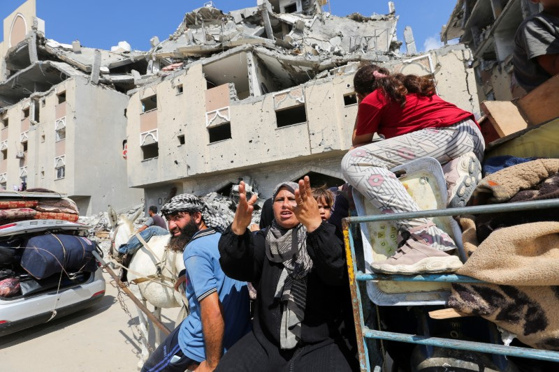 Displaced Palestinians make their way as they flee Hamad City following an Israeli evacuation order, in Khan Younis in the southern Gaza Strip