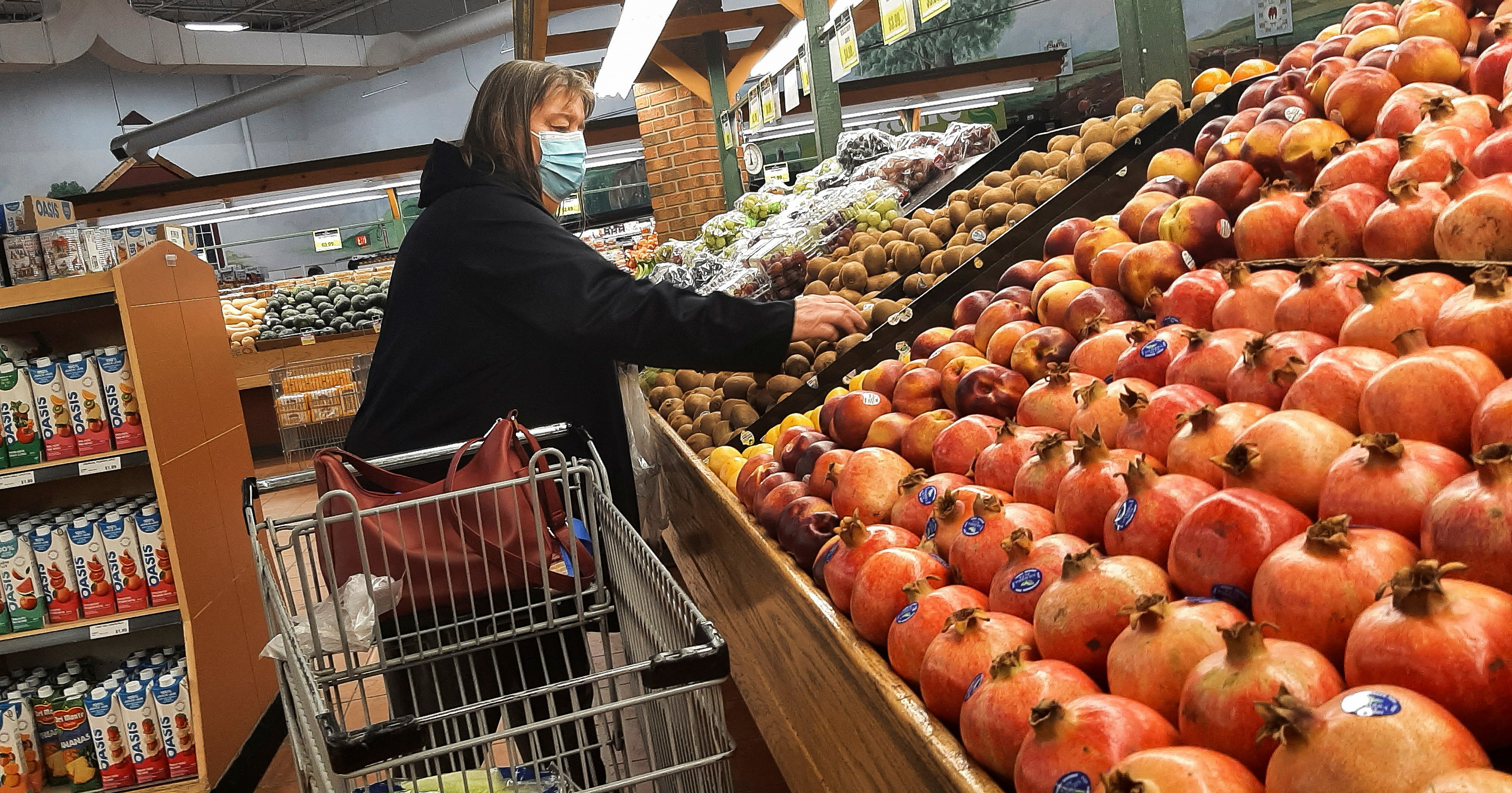 A person shops for vegetables at a supermarket in Ottawa