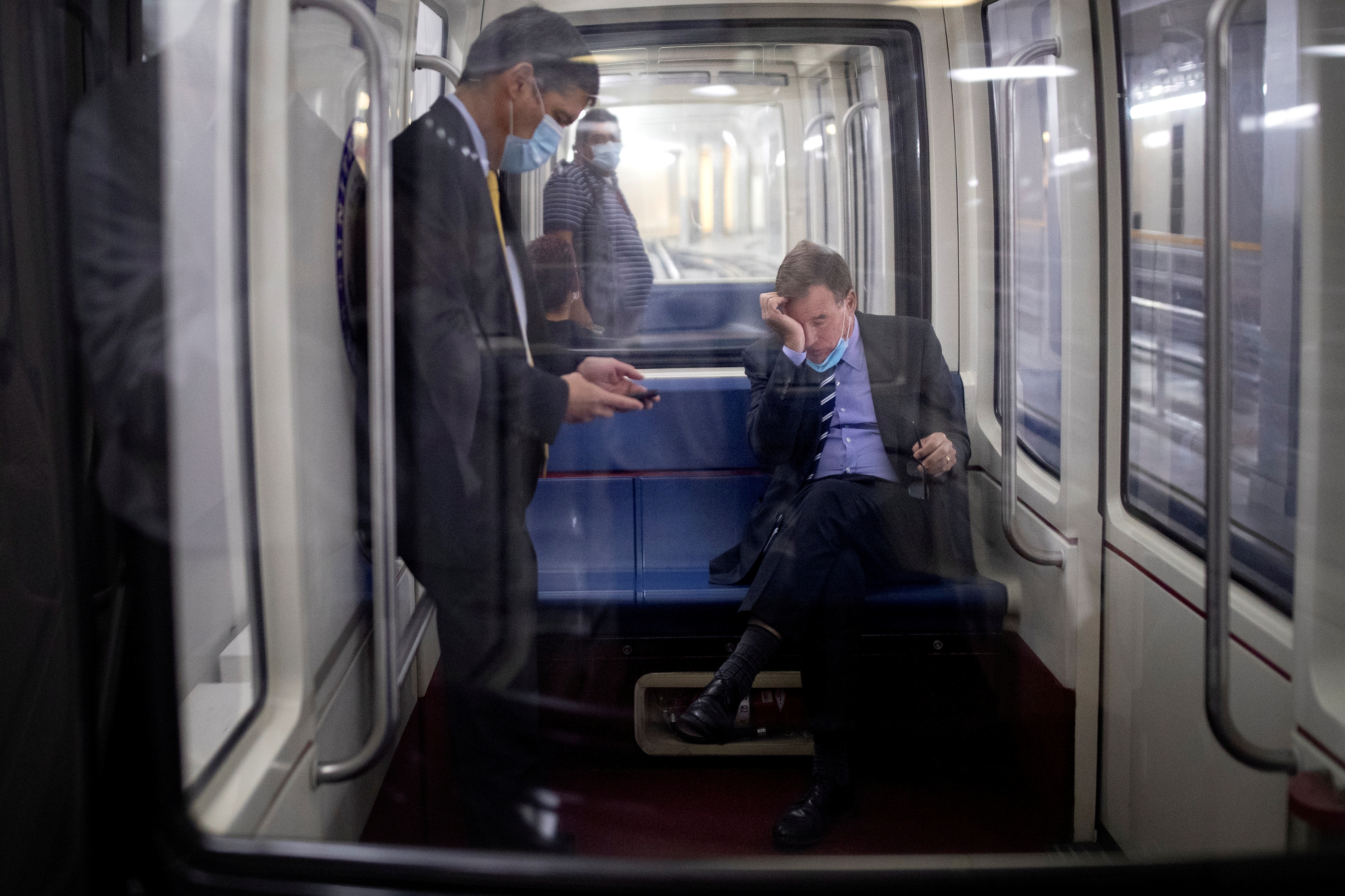 Senator Warner rides the Senate Subway following a vote on Capitol Hill in Washington