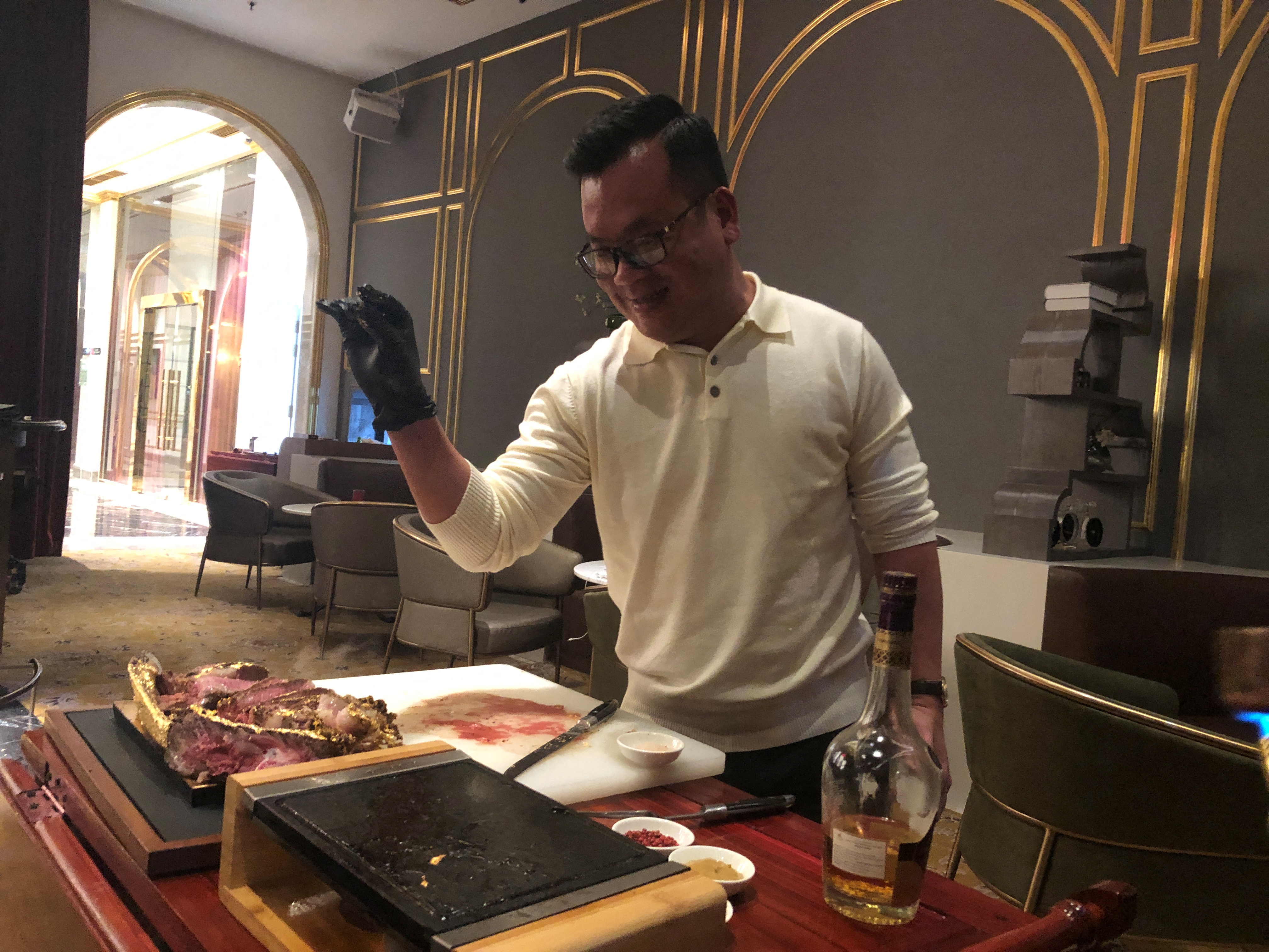 A chef prepares a gold leaf-coated steak, tapping in on a wave of publicity after a government minister was caught on camera being fed the dish at a London restaurant, at a Dolce By Wyndham Hanoi Golden Lake hotel, in Hanoi, Vietnam December 7, 2021. Picture taken December 7, 2021. REUTERS/Minh Nguyen