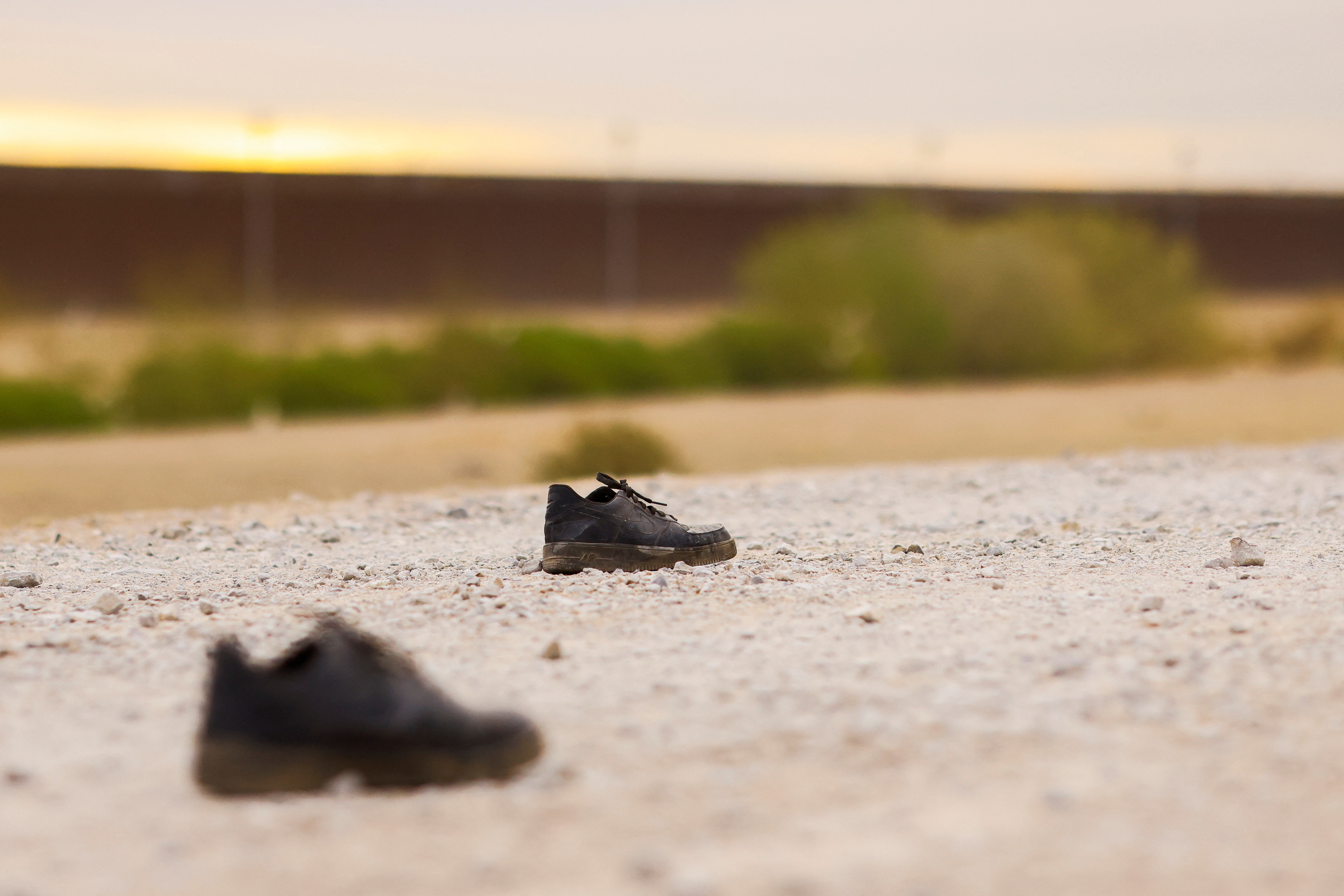A pair of shoes are seen on the banks of the Rio Bravo river, in Ciudad Juarez