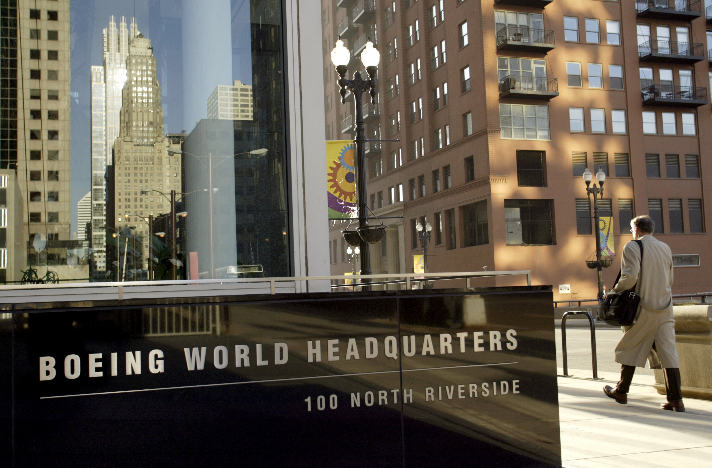 Pedestrian walks past Boeing World Headquarters office building in Chicago