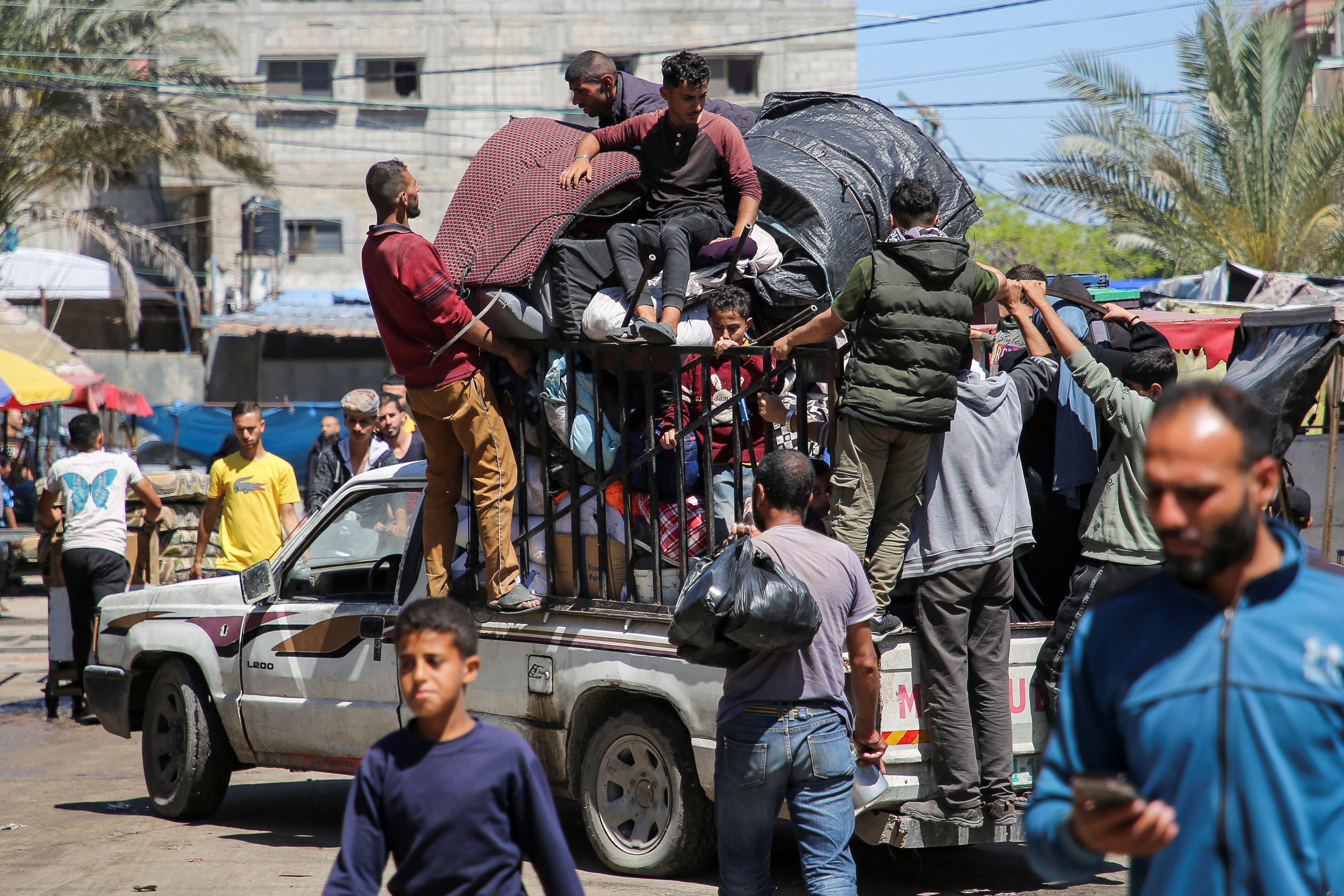 Palestinians evacuate after Israeli forces launched a ground and air operation in the eastern part of Rafah