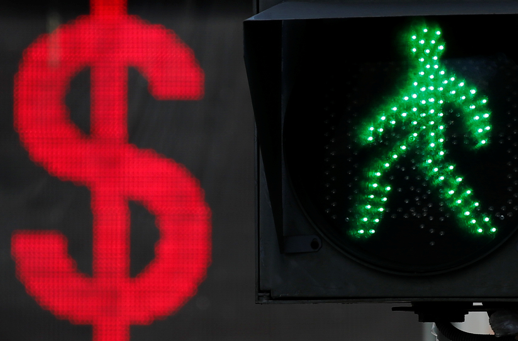 The U.S. dollar sign is seen on an electronic board next to a traffic light in Moscow