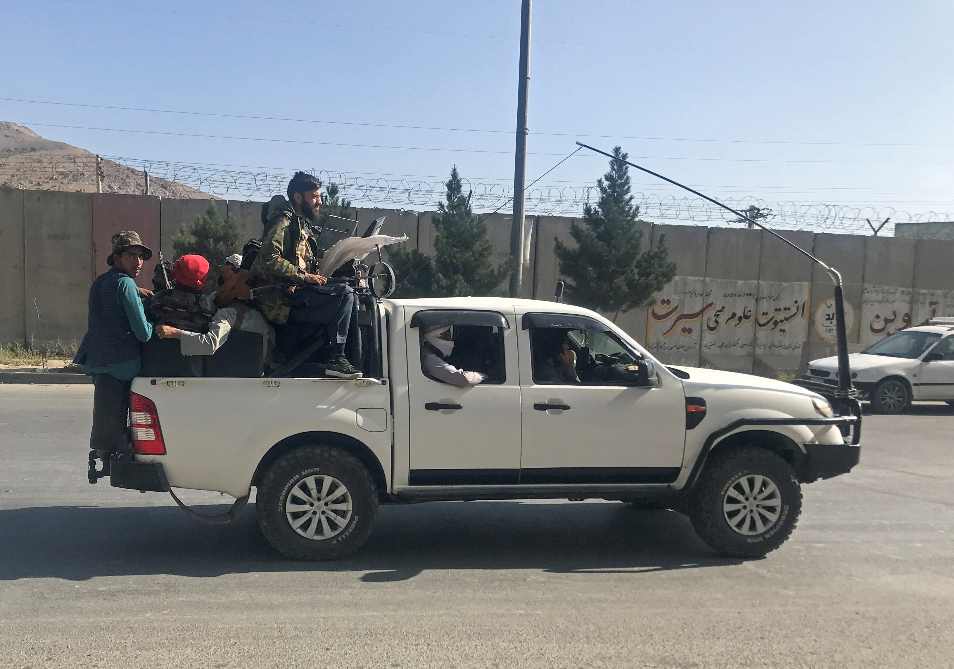 Taliban fighters ride on a vehicle in Kabul, Afghanistan, August 16, 2021.REUTERS/Stringer