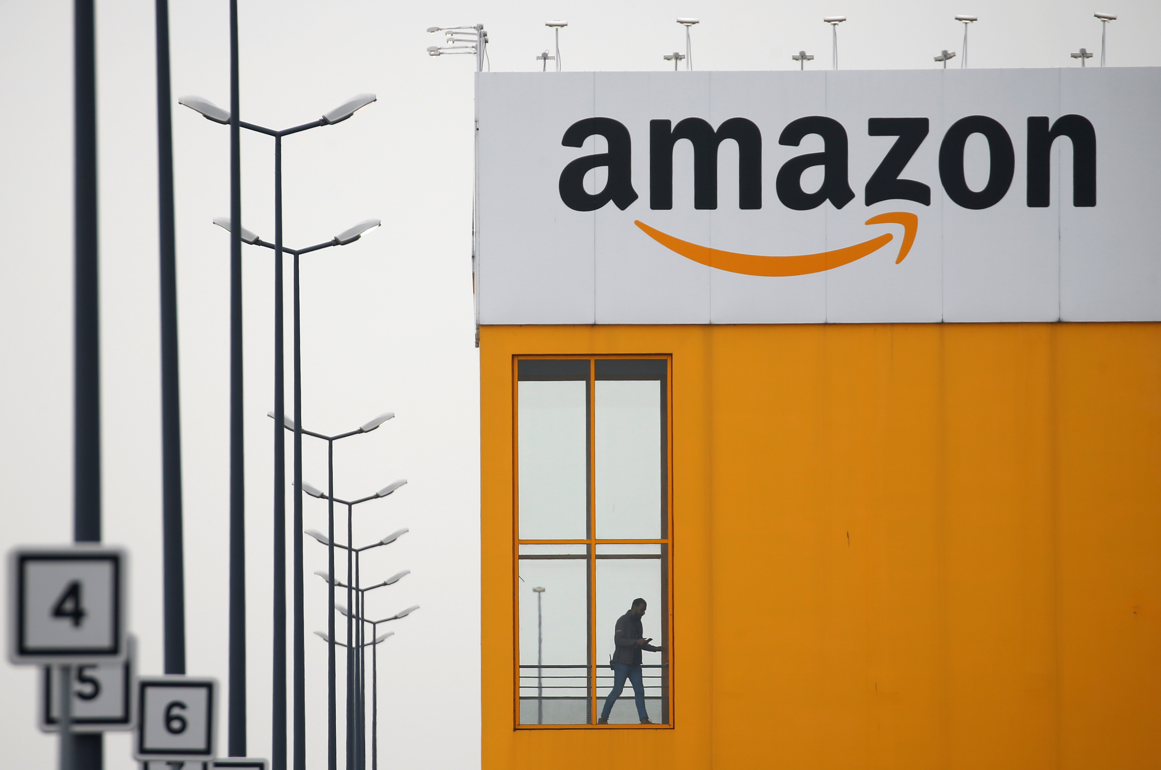 The logo of Amazon is seen at the company logistics center in Lauwin-Planque