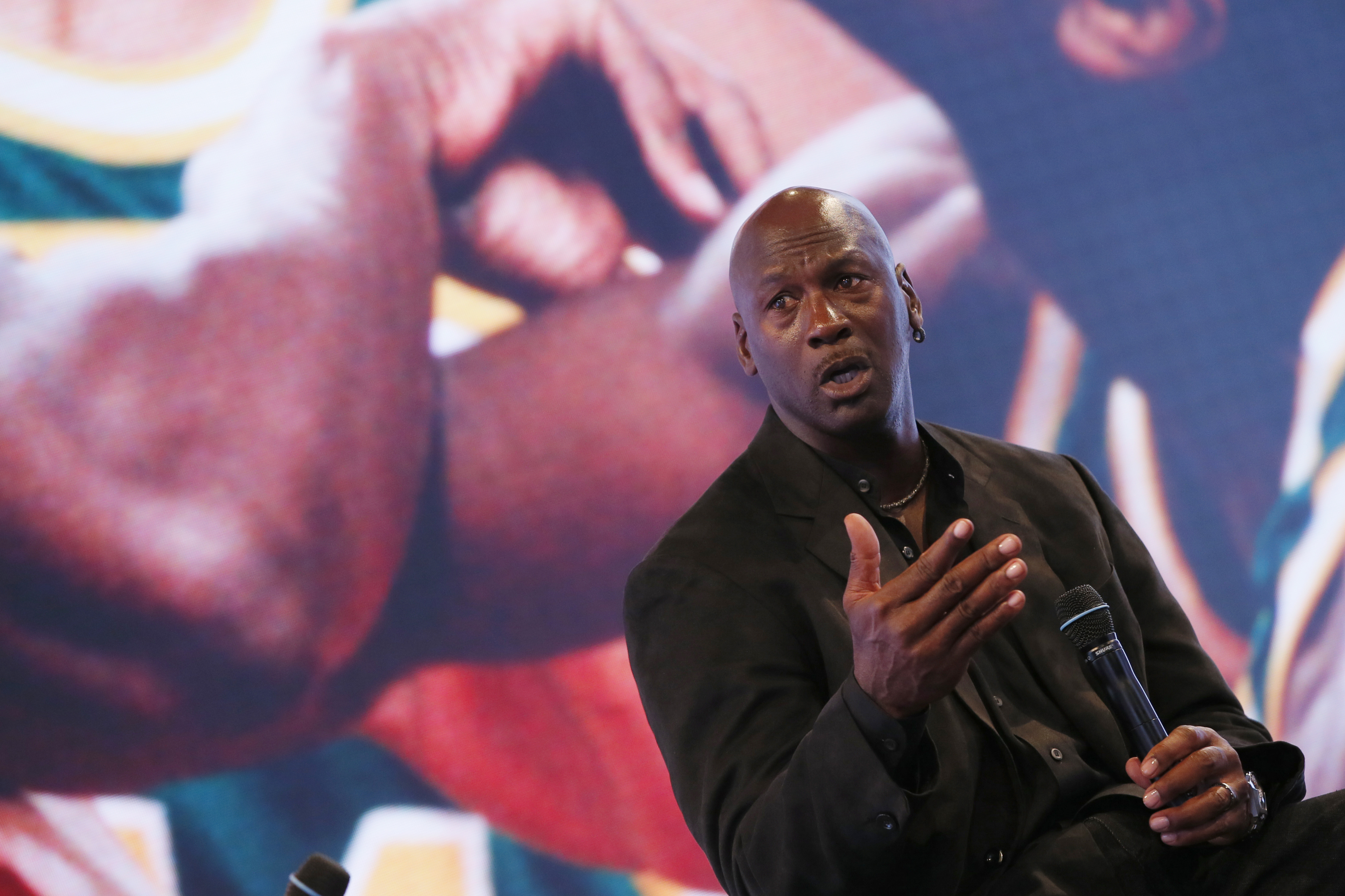 Former basketball great Michael Jordan delivers a speech as he attends a party celebrating the 30th anniversary of the Air Jordan shoe line in Paris