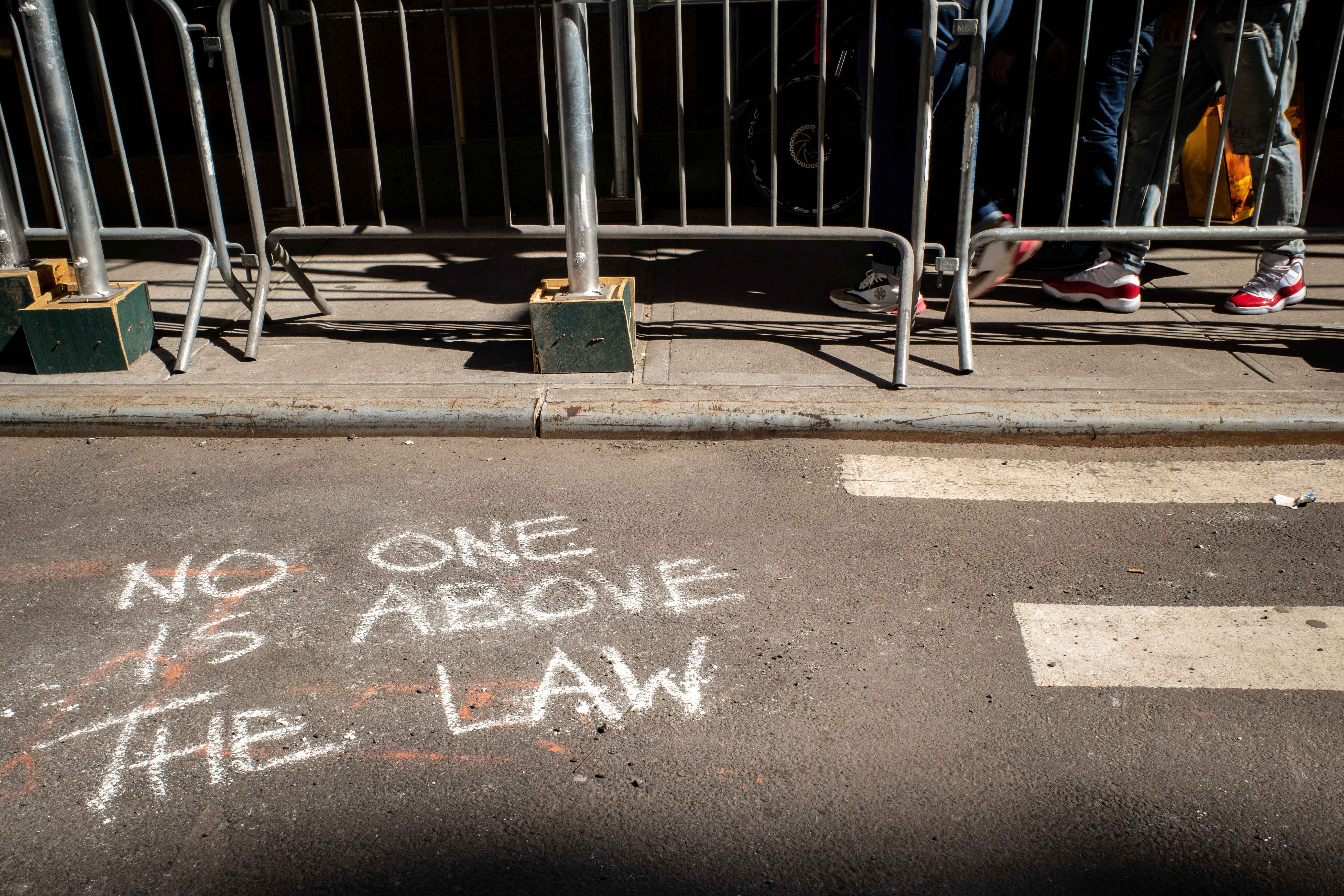 Chalk graffiti is seen on the ground outside of the Manhattan District Attorney's Office in New York