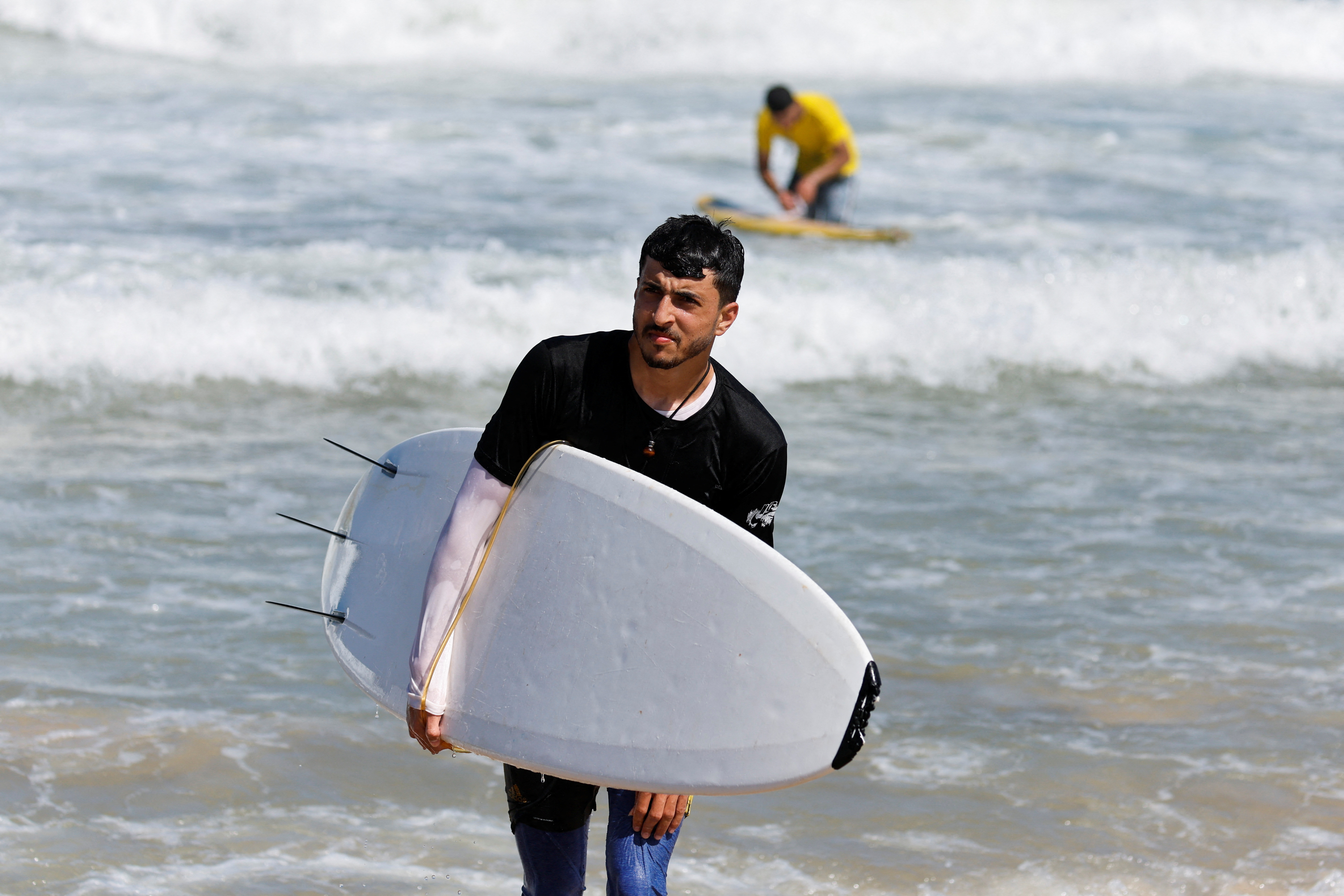 With eyes on the waves, Gaza surfers keep boards handy | Reuters