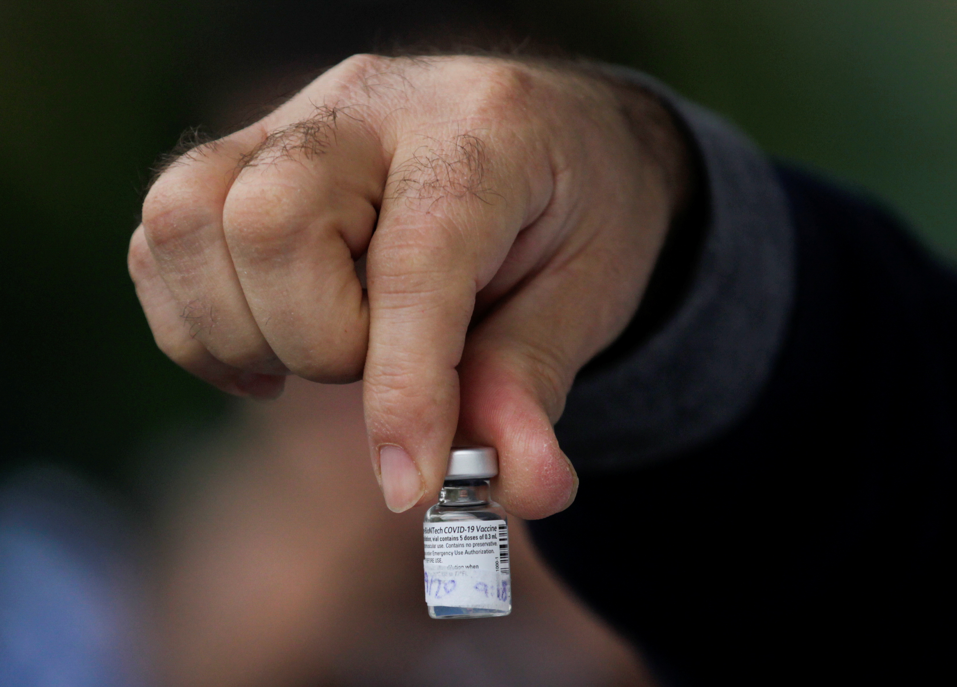 A medical worker shows a dose of the Pfizer-BioNTech COVID-19 vaccine at the Regional Military Specialty Hospital in San Nicolas de los Garza, on the outskirts of Monterrey