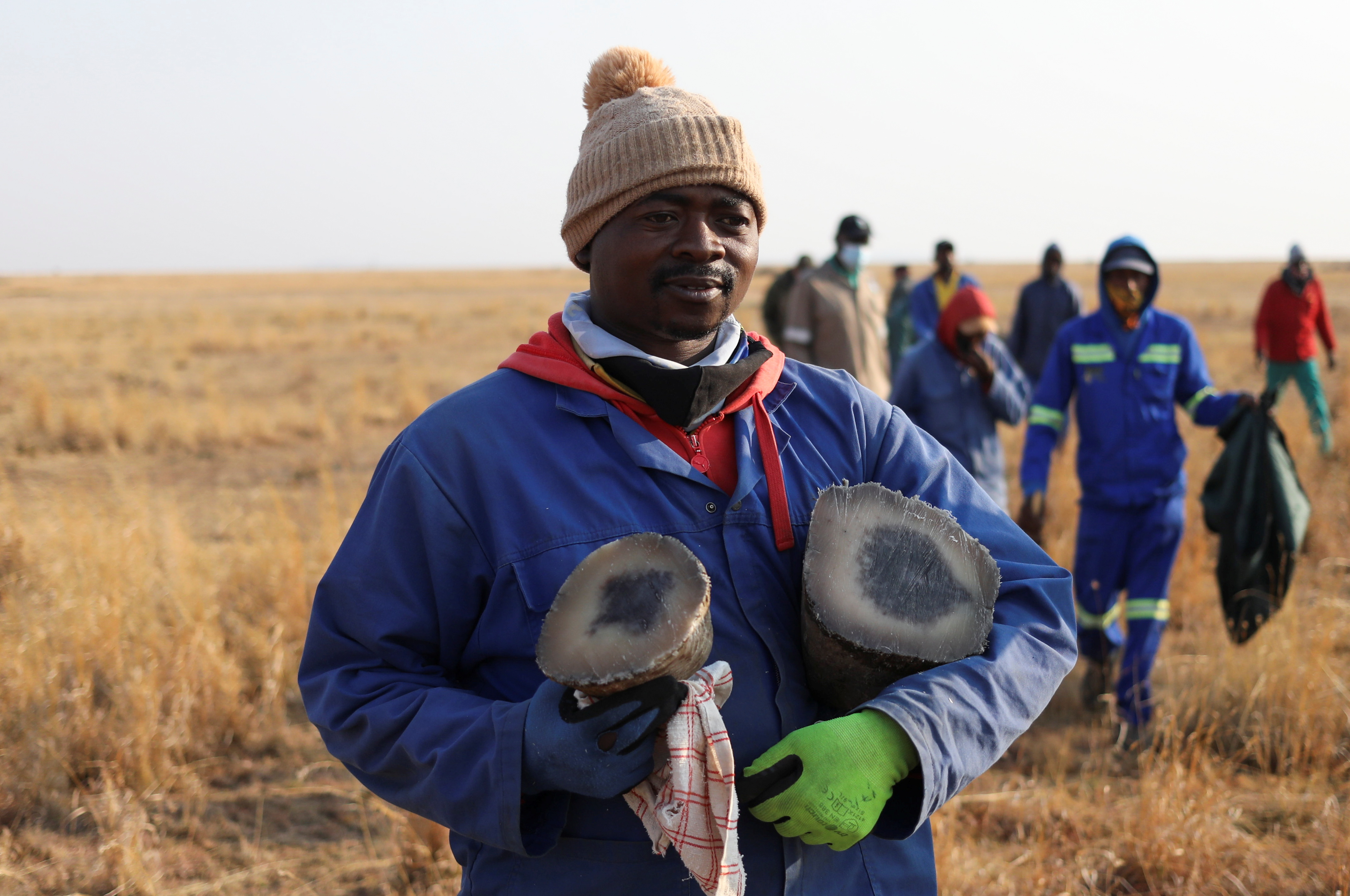 A worker carries rhino horns after it was dehorned at the Buffalo Dream Ranch, the biggest private rhino sanctuary on the continent, in Klerksdorp, South Africa's North West Province, September 6, 2021. Picture taken September 6, 2021. REUTERS/Siphiwe Sibeko