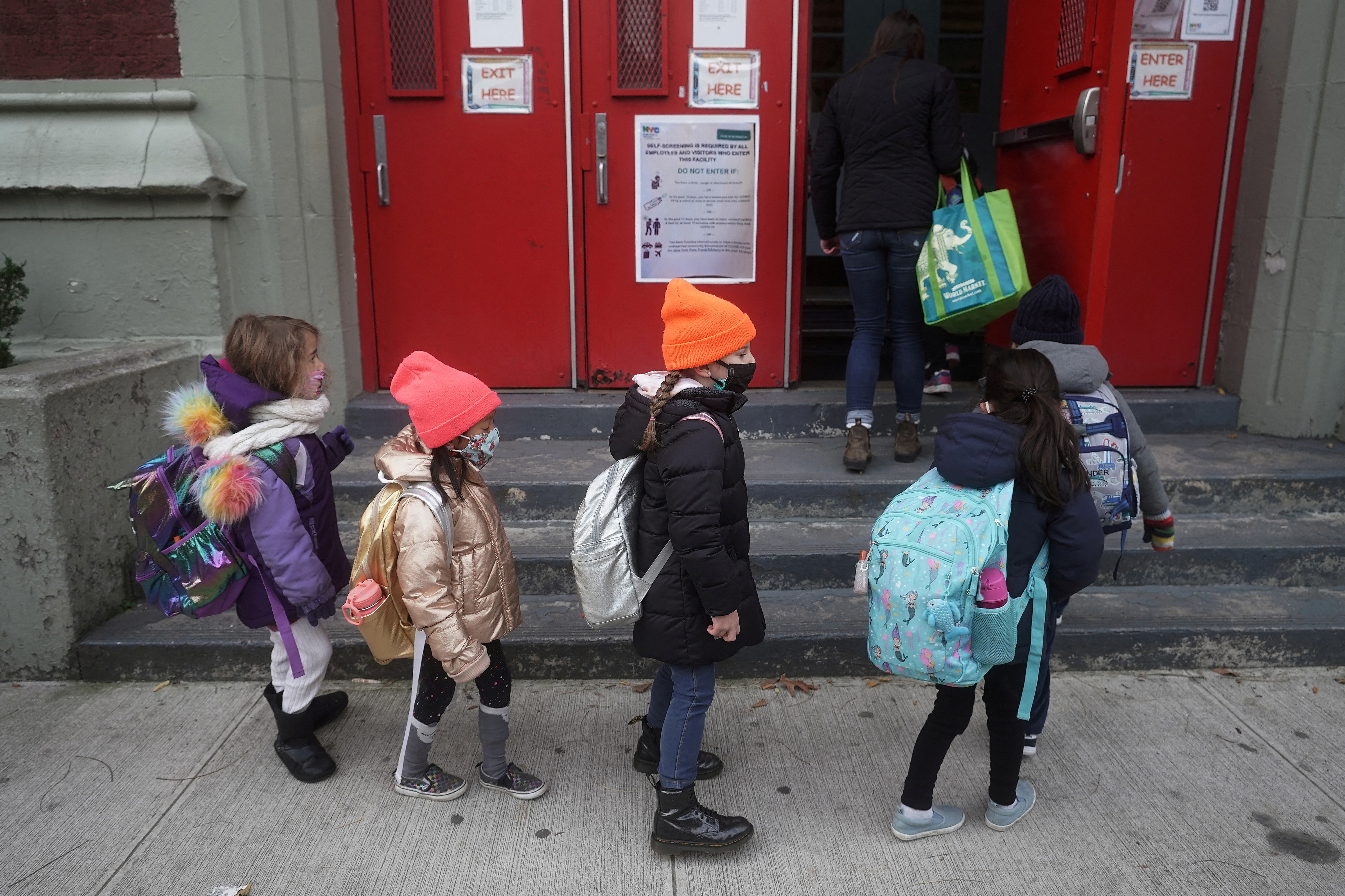 Children line up to attend class at PS 361 on the first day of a return to class during the coronavirus disease (COVID-19) pandemic in the Manhattan borough of New York City, New York, U.S., December 7, 2020. REUTERS/Carlo Allegri/File Photo