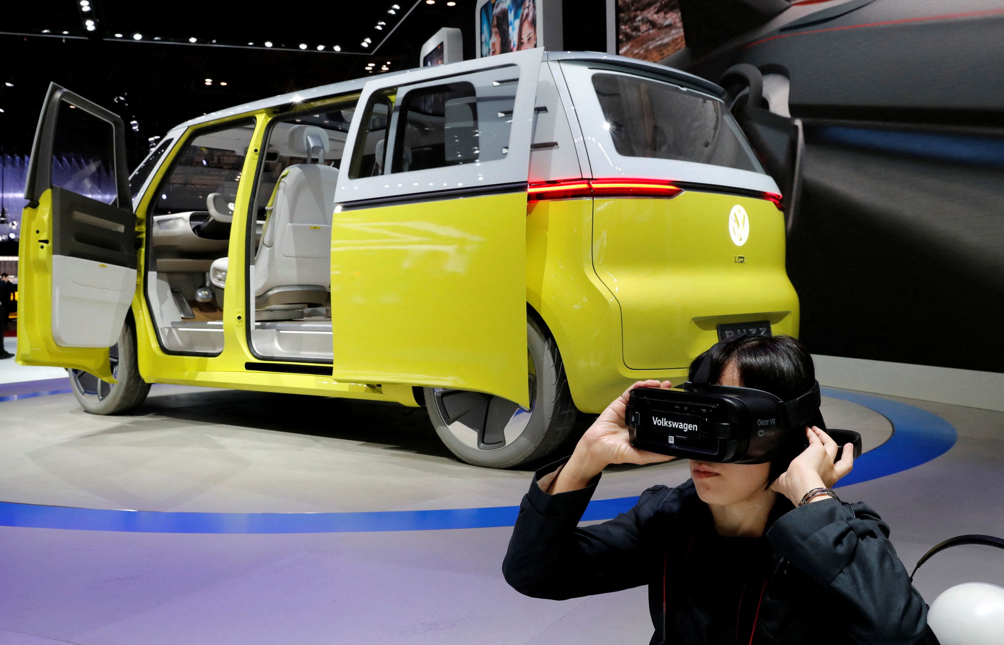 A visitor uses virtual reality device next to Volkswagen's concept I.D. Buzz during media preview of the 45th Tokyo Motor Show in Tokyo