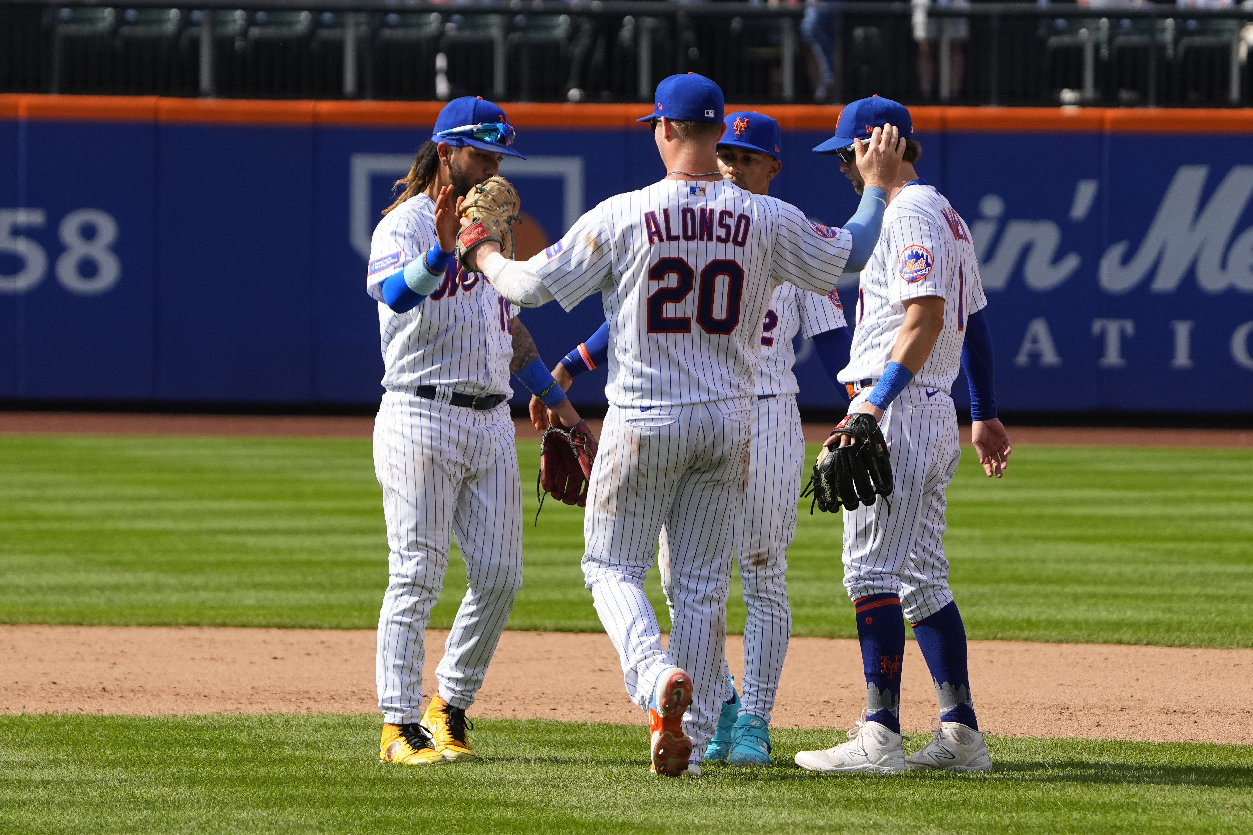 New York Mets Pete Alonso (20) congratulates New York Mets Francisco Lindor  (12) on his home run against the Chicago Cubs during the first inning of a  baseball game Wednesday, April 21