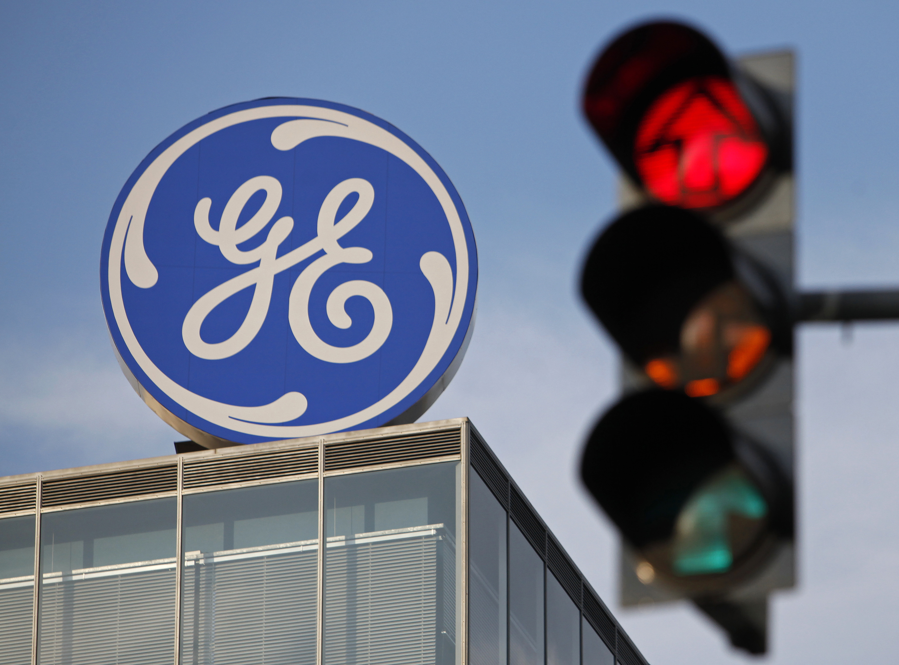 The logo of the GE Money Bank is seen behind a traffic light in Prague