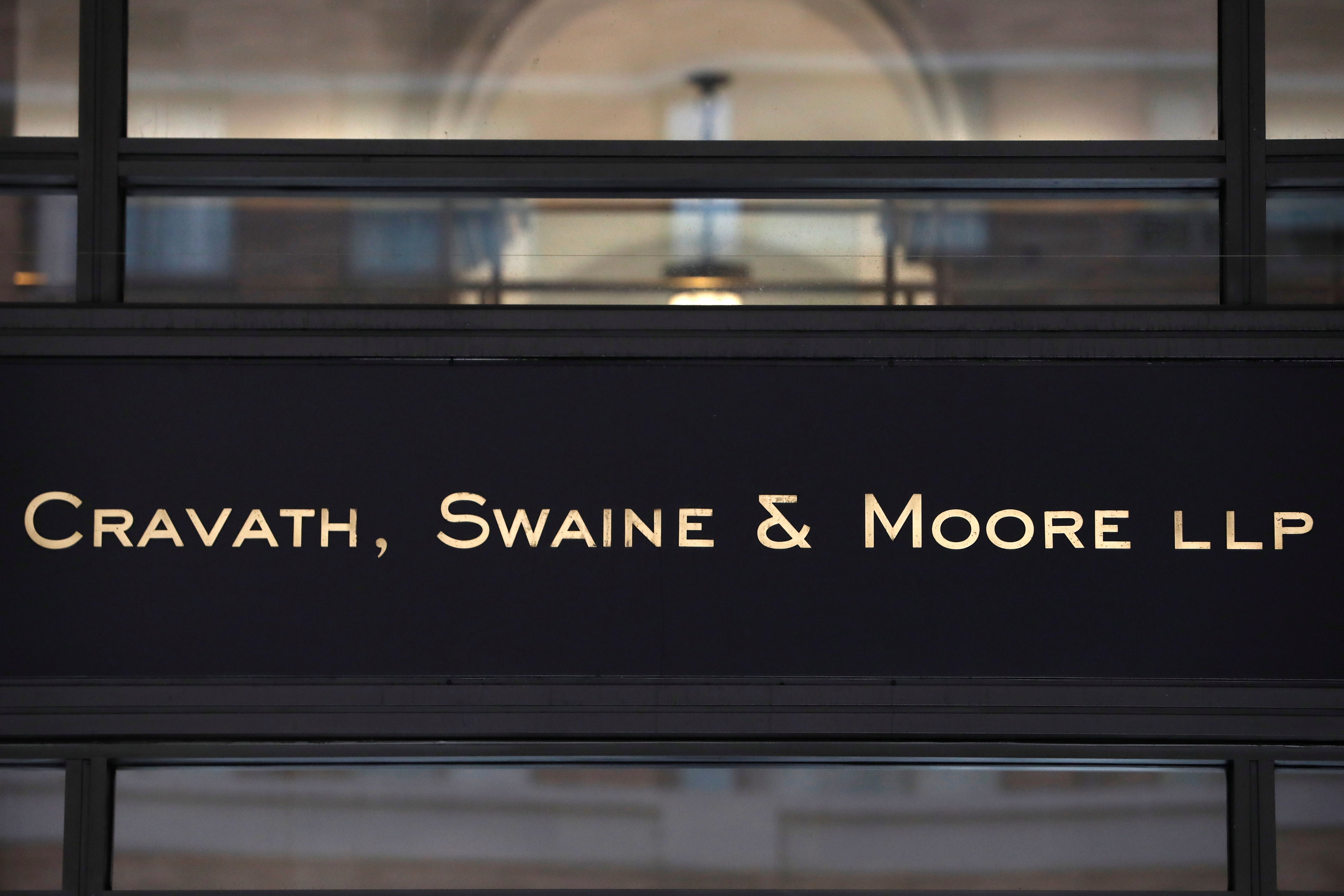 Signage is seen on the exterior of the building where law firm Cravath, Swaine & Moore LLP are located in Manhattan, New York City