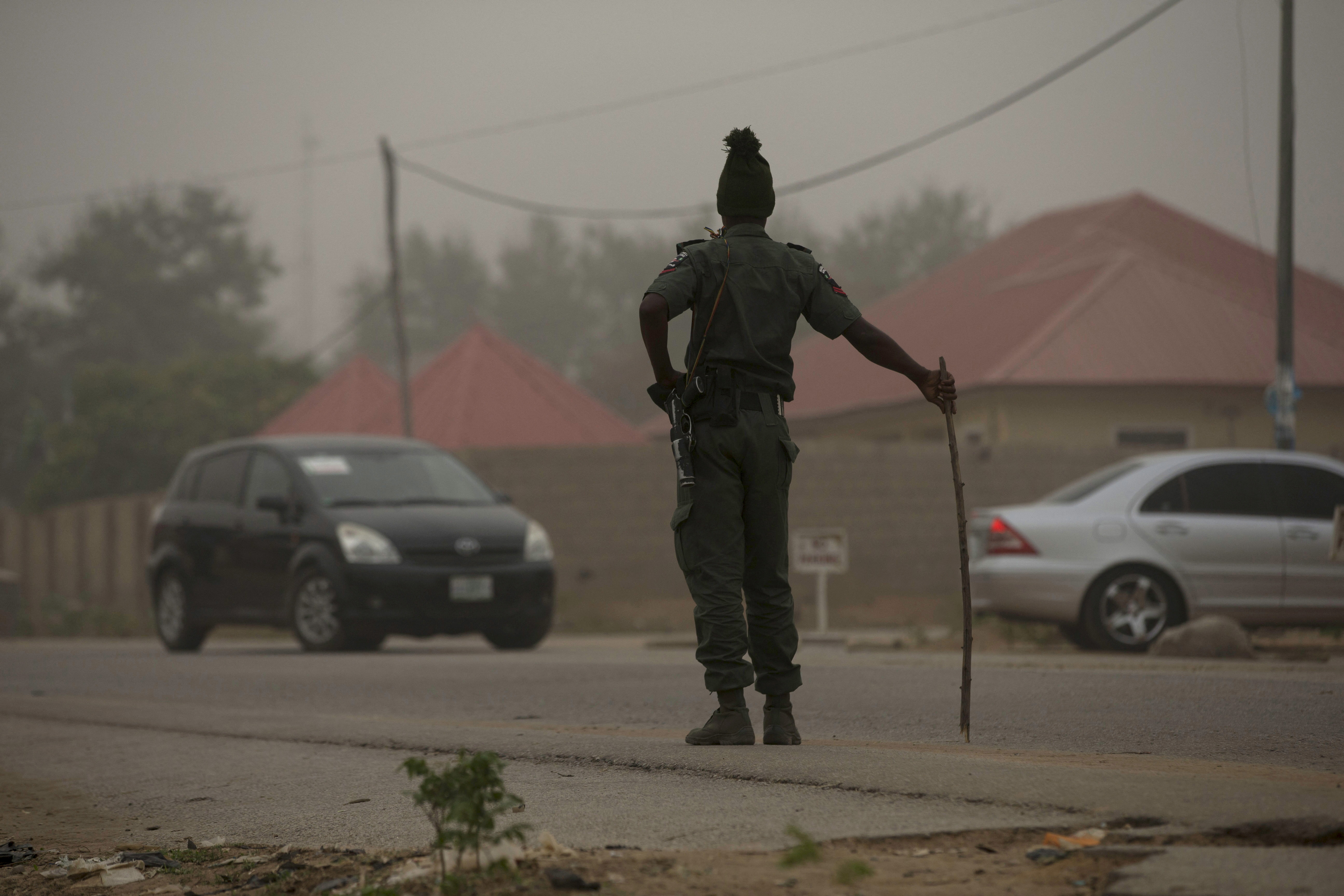 A policeman keeps watch on the road leading to Taraba state electoral commission during the announcement of the results of the Governorship and State assembly elections in Jalingo