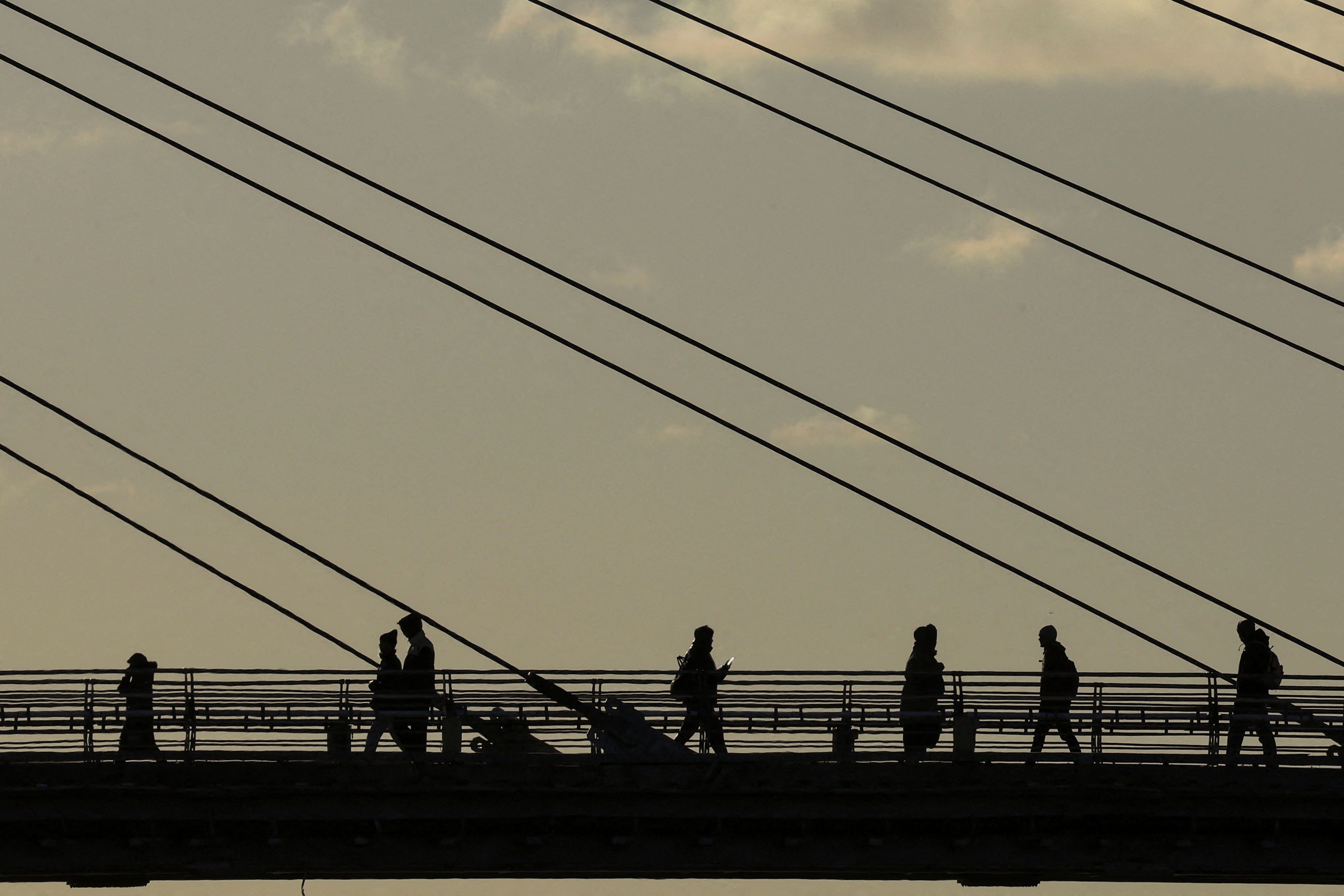 People walk a bridge in Krasnogorsk outside Moscow