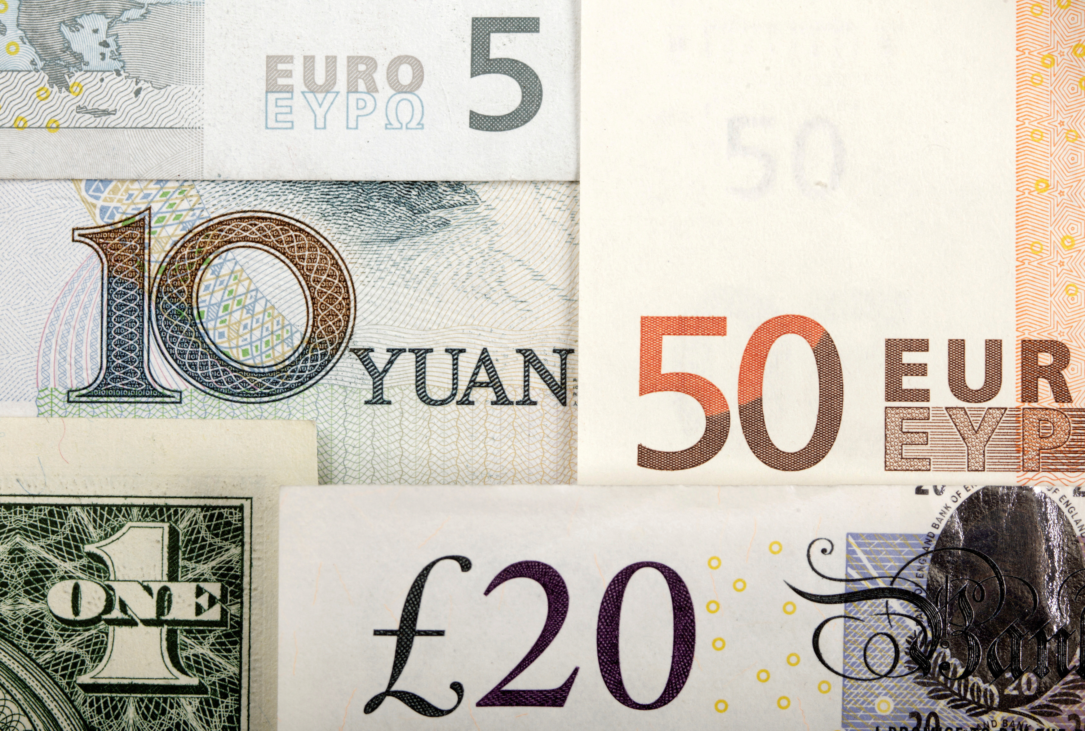 Arrangement of various world currencies including Chinese Yuan, US Dollar, Euro, British Pound