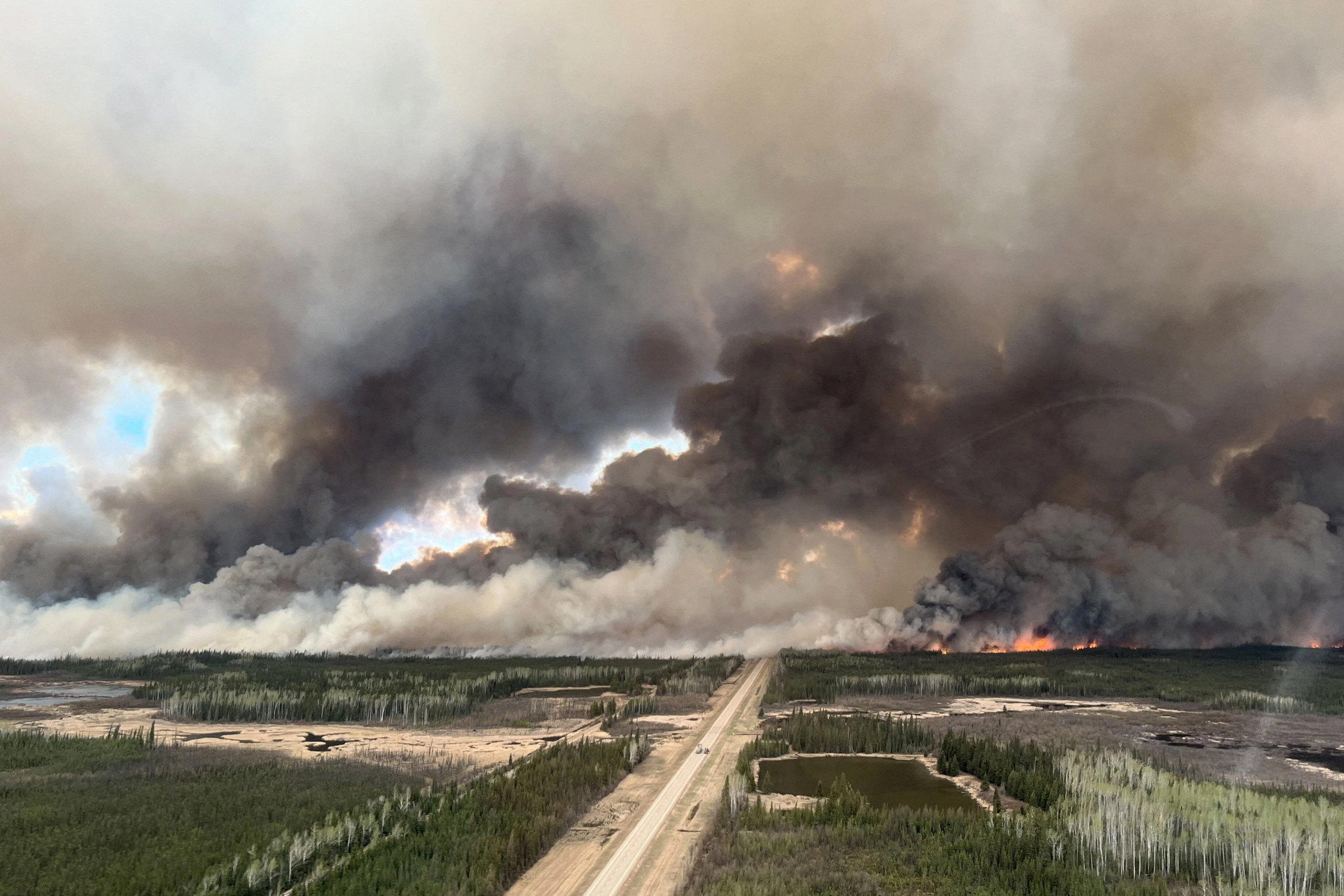 Smoke rises from mutual aid wildfire HTZ001 in the High Level Forest Area