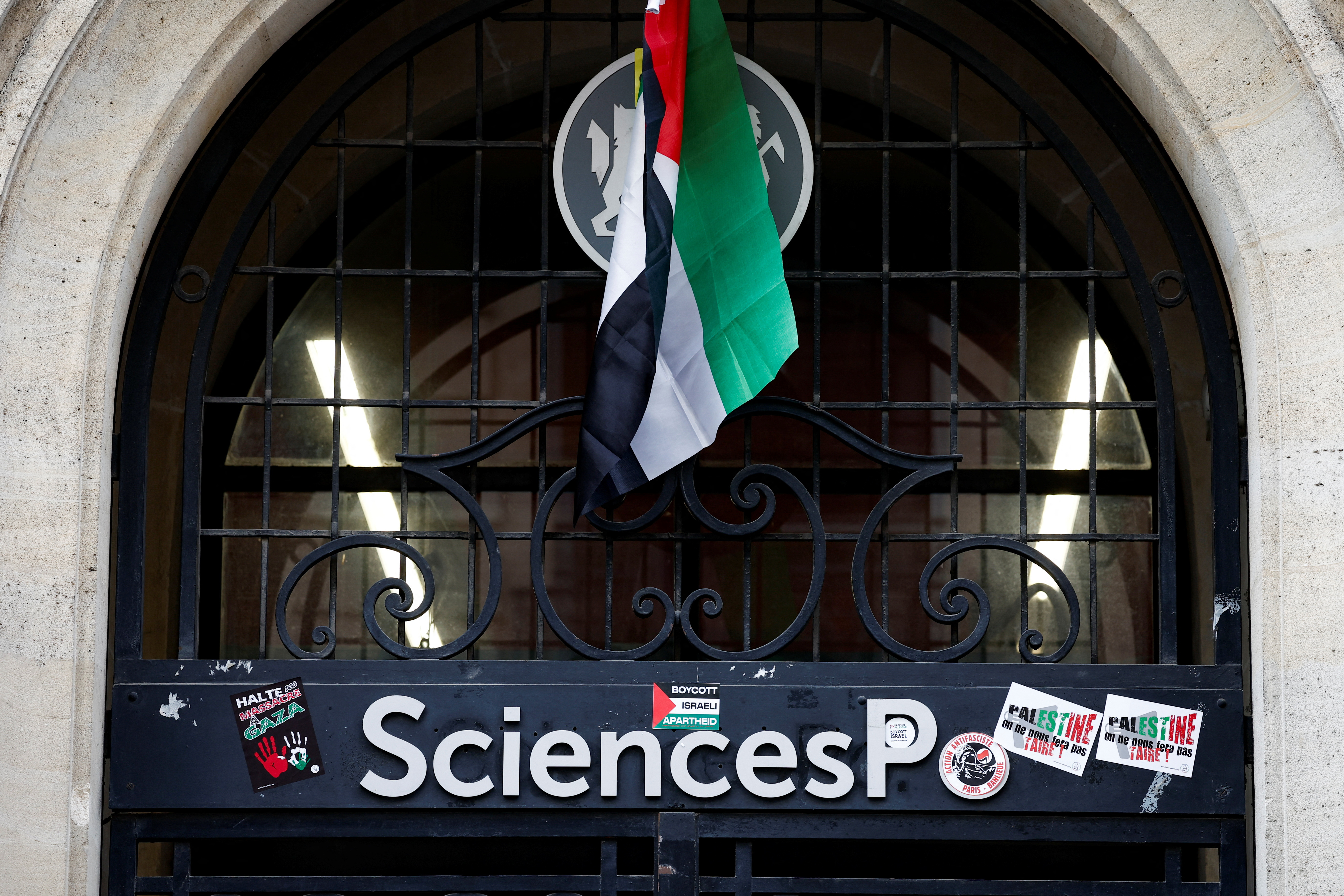 Masked youths take part in the occupation of a building of the Sciences Po University in support of Palestinians in Gaza, in Paris