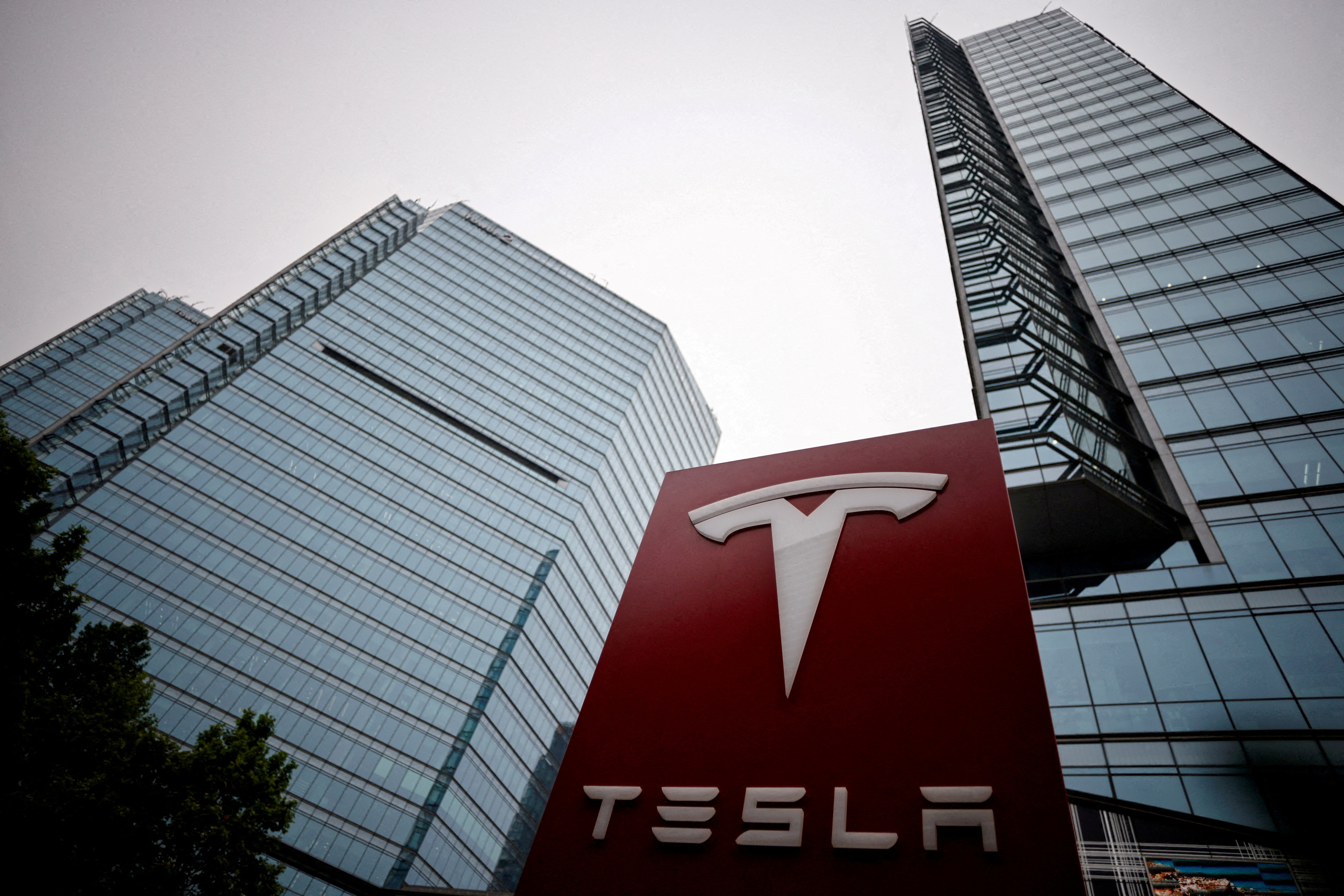 A Tesla logo is seen outside a showroom of the carmaker in Beijing