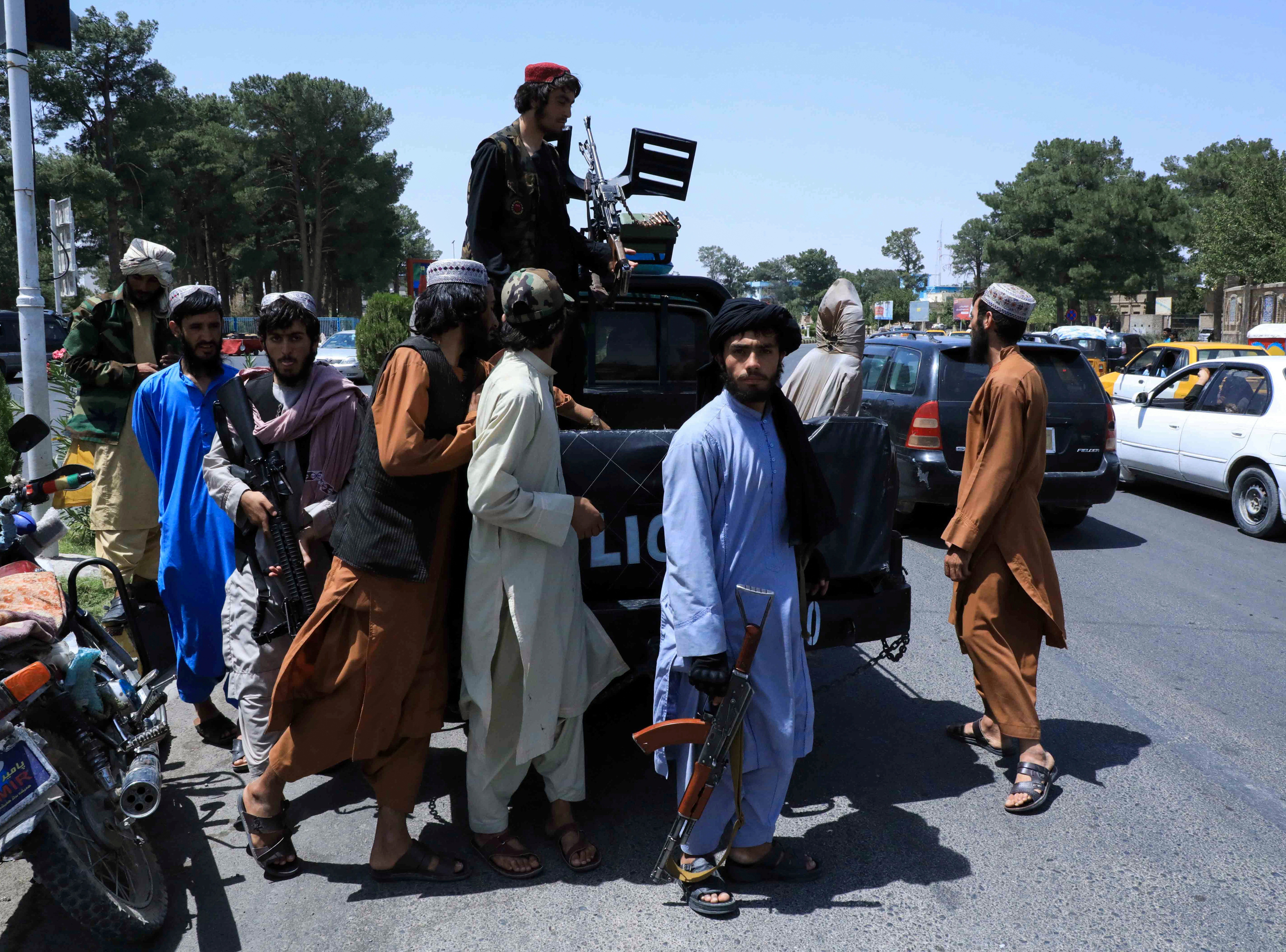 Taliban forces patrol a street in Herat