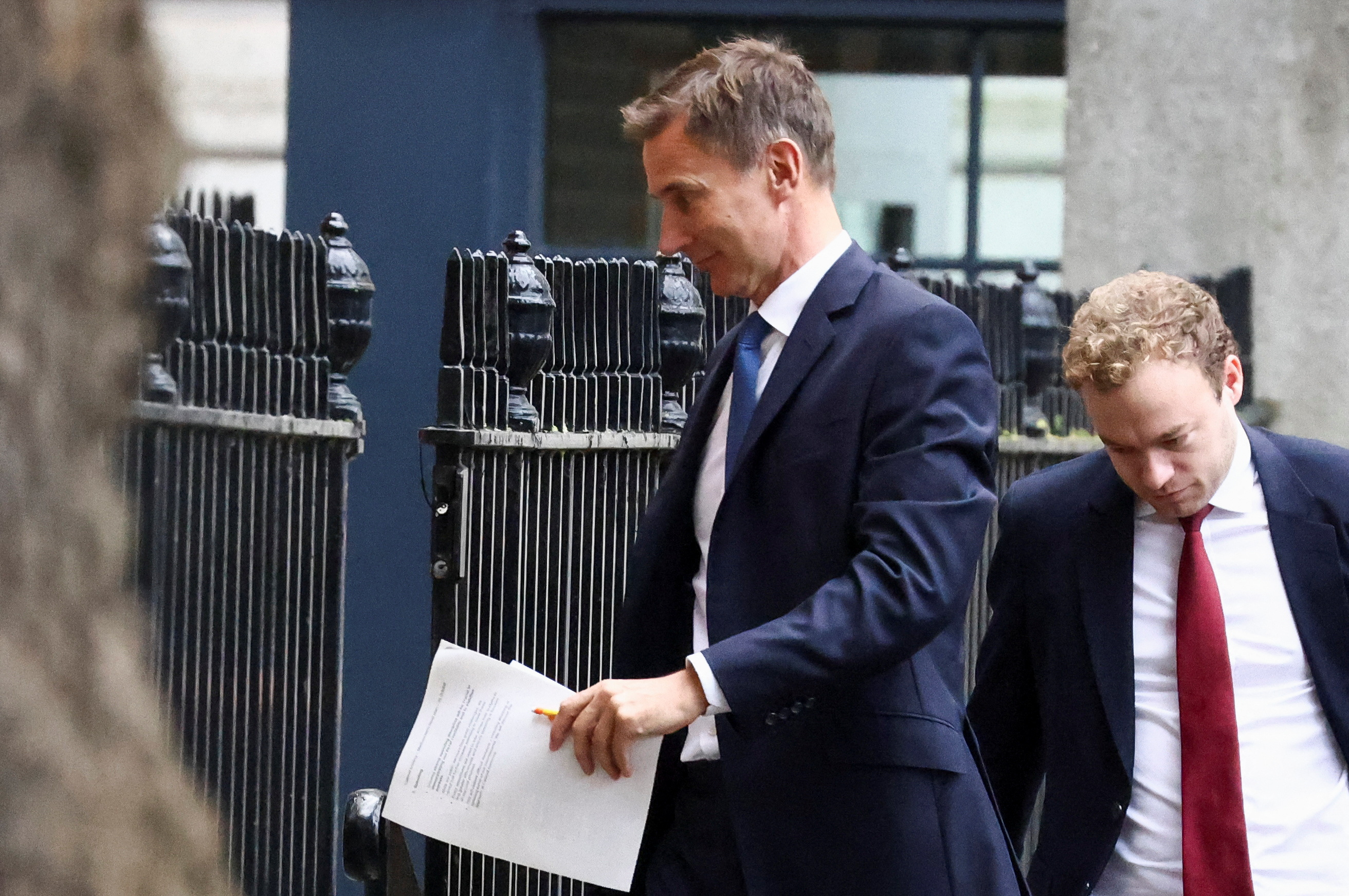British Chancellor of the Exchequer Jeremy Hunt walks outside Downing Street