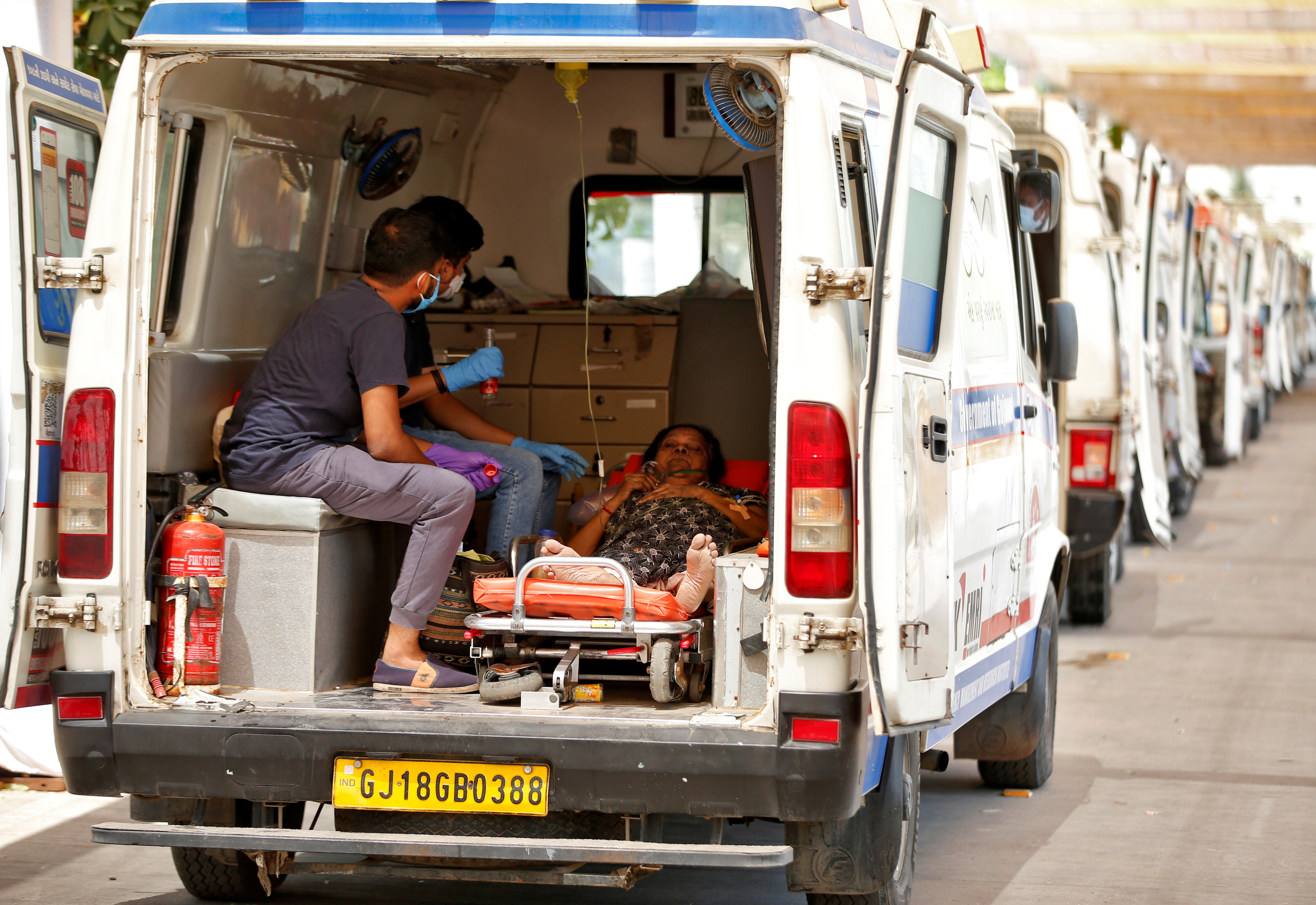 India Covid cases cross 18 million, gravediggers work round the clock 8 A woman with breathing problem waits inside an ambulance for her turn to enter a COVID-19 hospital for treatment, amidst the spread of the coronavirus disease (COVID-19) in Ahmedabad, India, April 28, 2021. REUTERS/Amit Dave