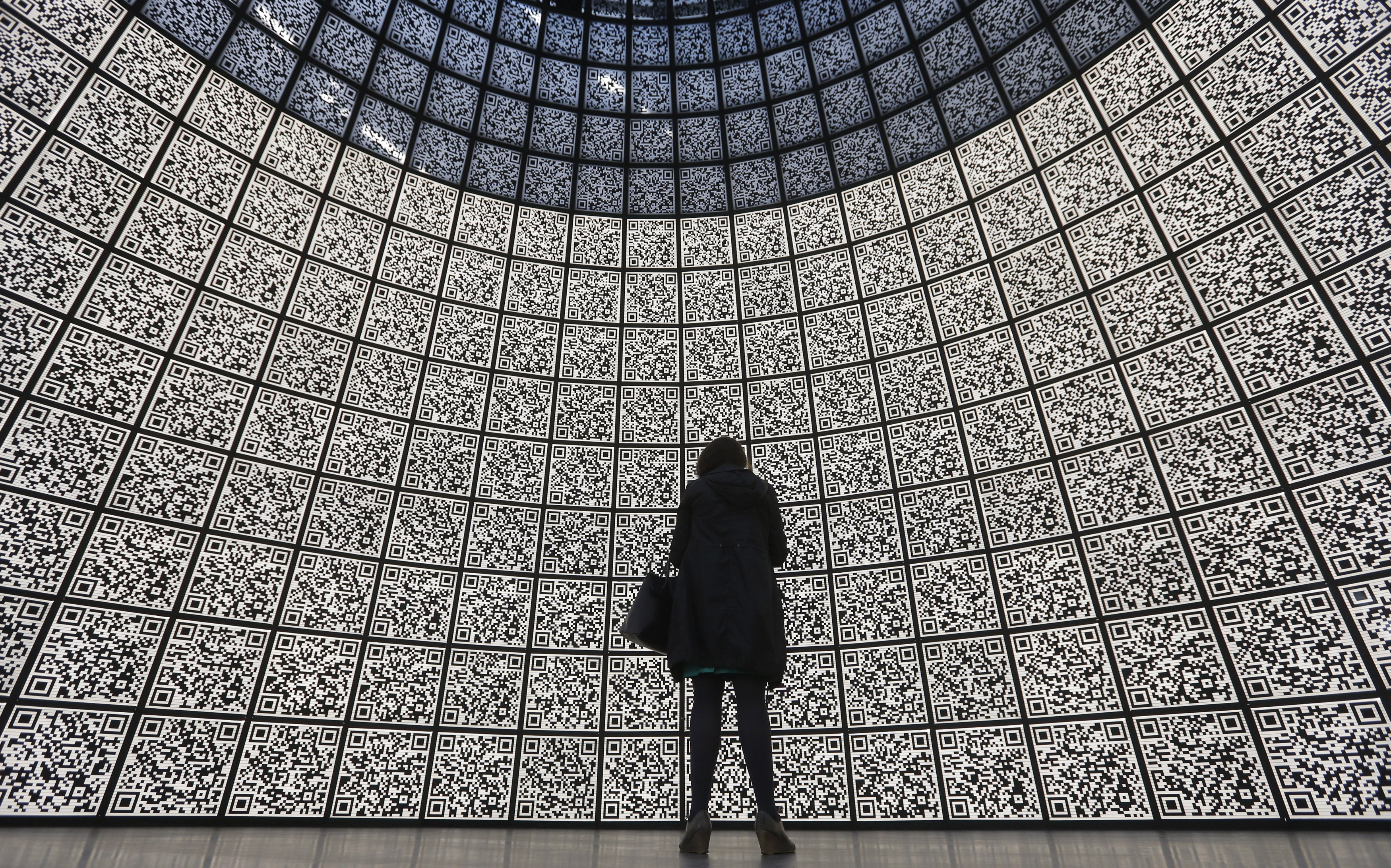 A visitor stands in front of QR-codes information panels during a ceremony to open an information showroom dedicated to the Zaryadye park project in central Moscow