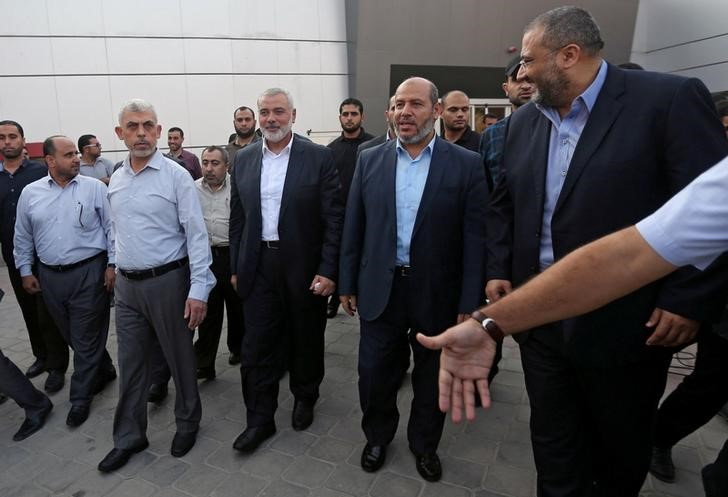 Hamas Gaza Chief Yahya Al-Sinwar, Hamas Chief Ismail Haniyeh and senior Hamas leader Khalil al-Hayya arrive at the Rafah border crossing in the southern Gaza Strip