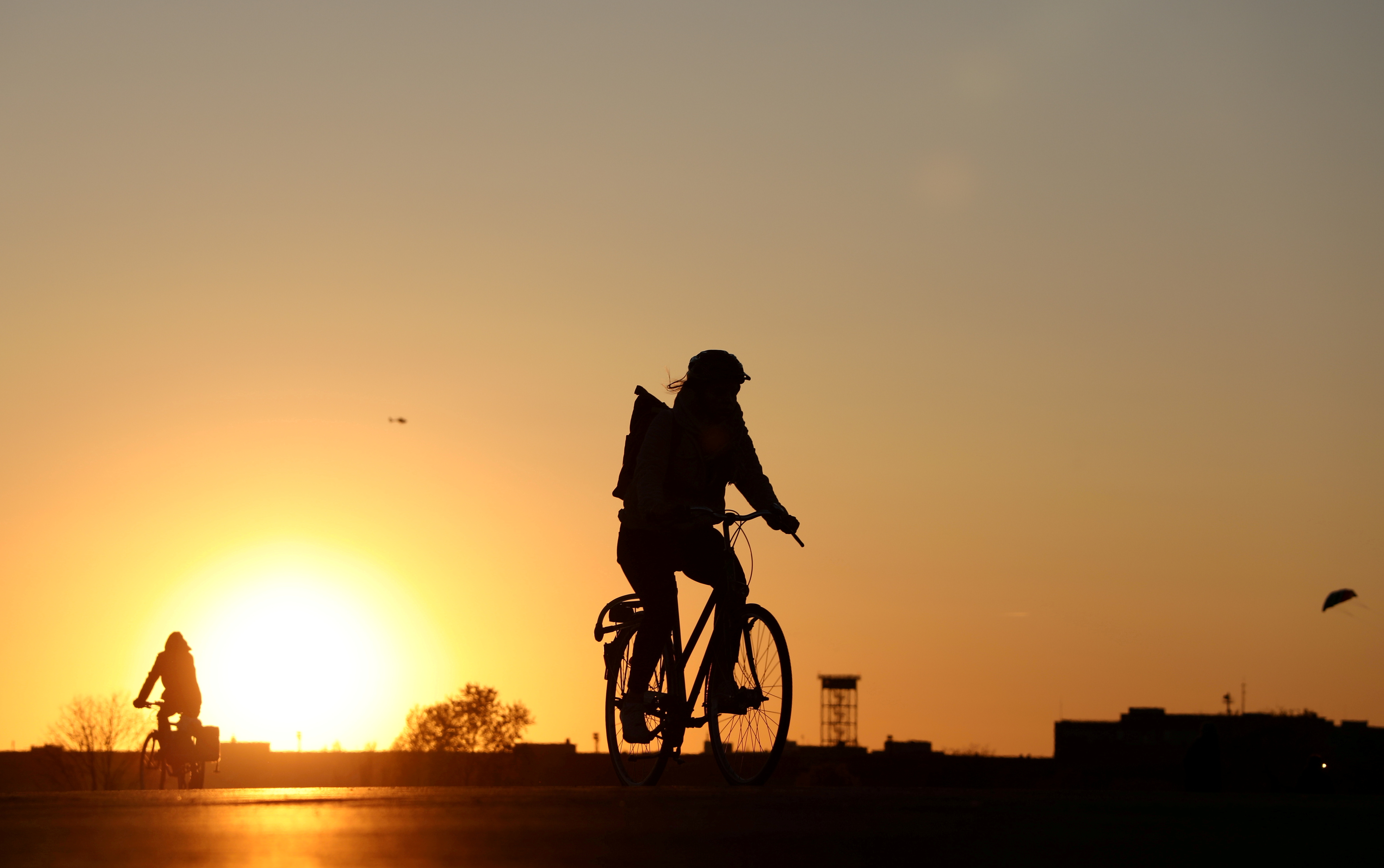 People on bikes enjoy the sunset at the Tempelhofer Feld, as the spread of coronavirus disease (COVID-19) continues in Berlin, Germany, April 19, 2020. REUTERS/Christian Mang/File Photo