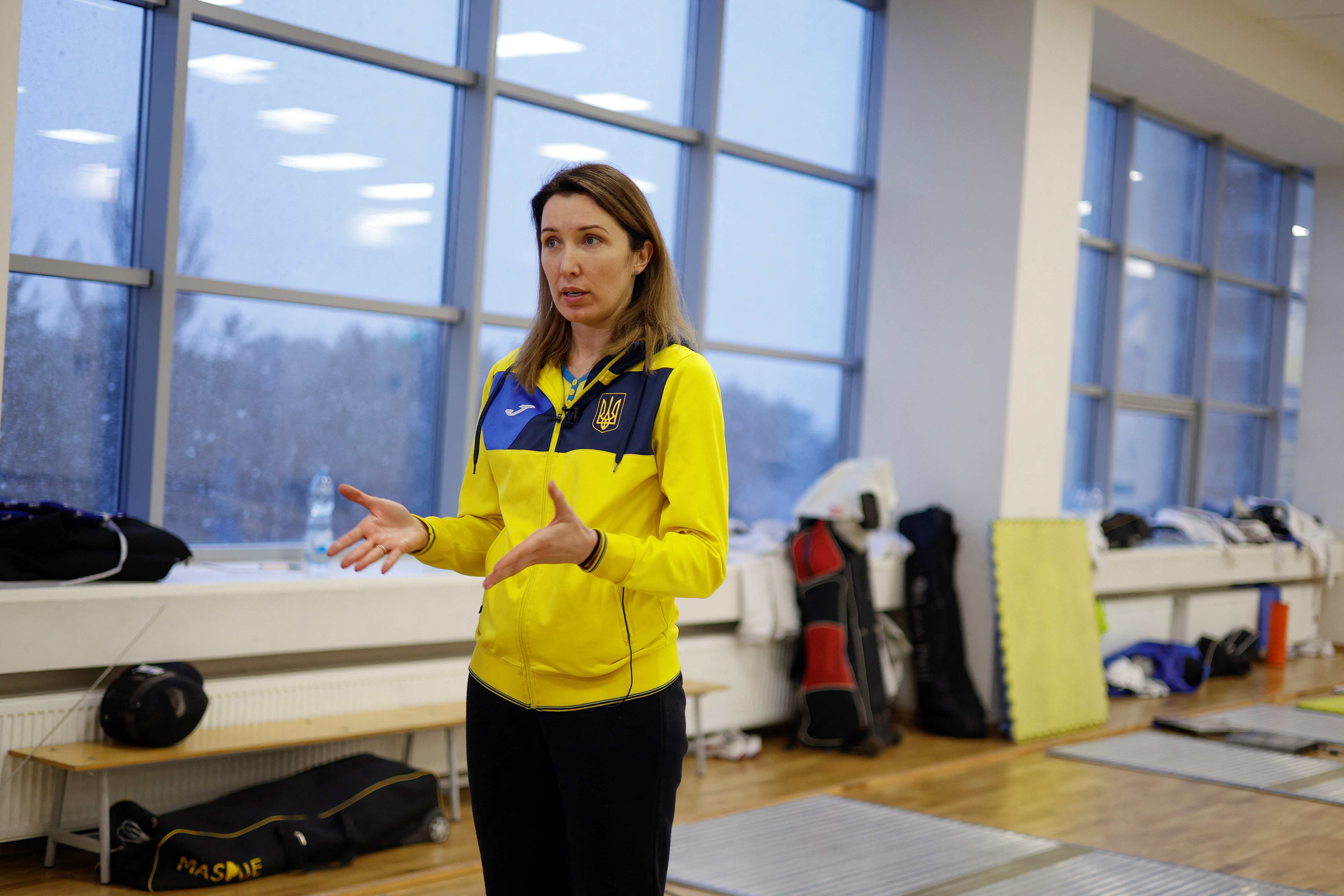 Senior coach of Ukraine's fencing team Olha Leleiko speaks to Reuters journalist after a training session at the Olympic training base in Kyiv