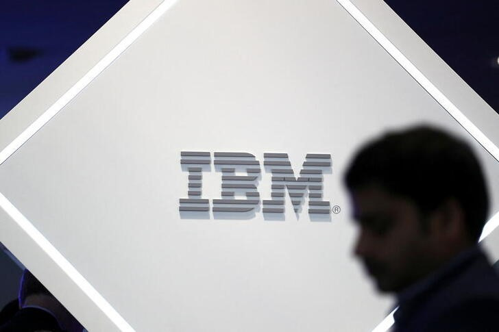 A man stands near an IBM logo at the Mobile World Congress in Barcelona