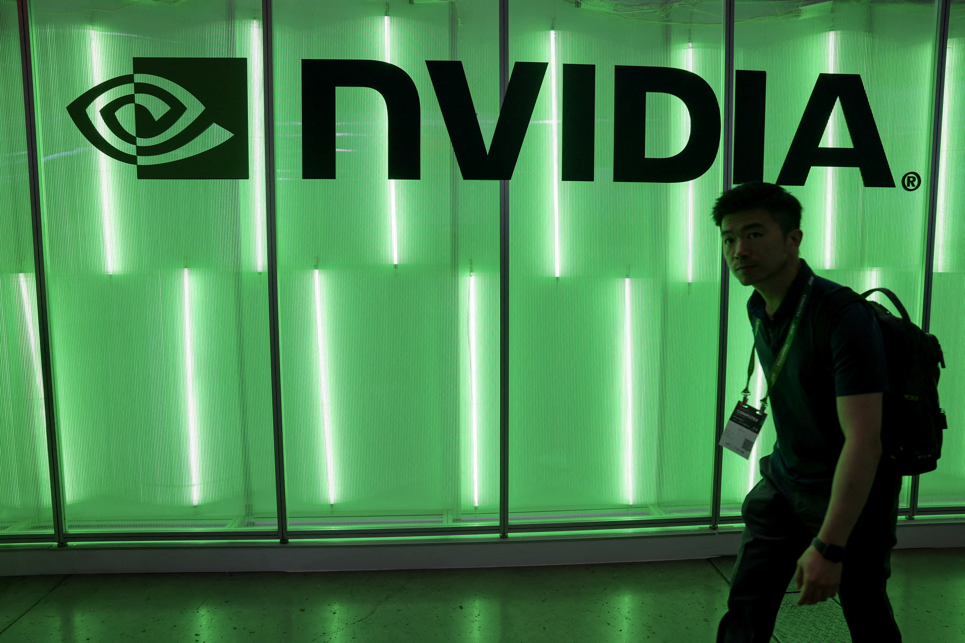A person walks pass a Nvidia logo at Computex in Taipei