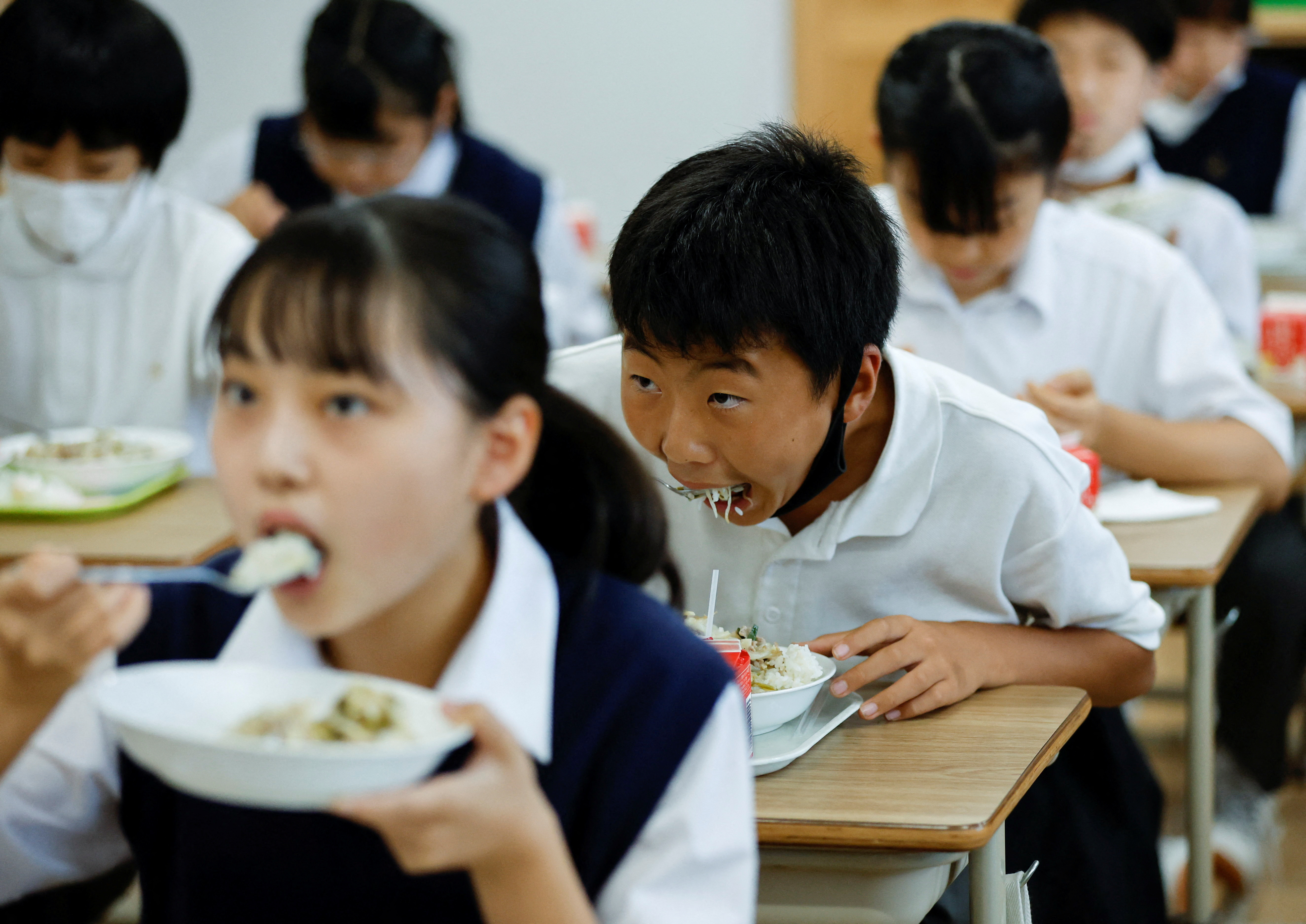 Students take a school lunch at Senju Aoba Junior High School in Tokyo