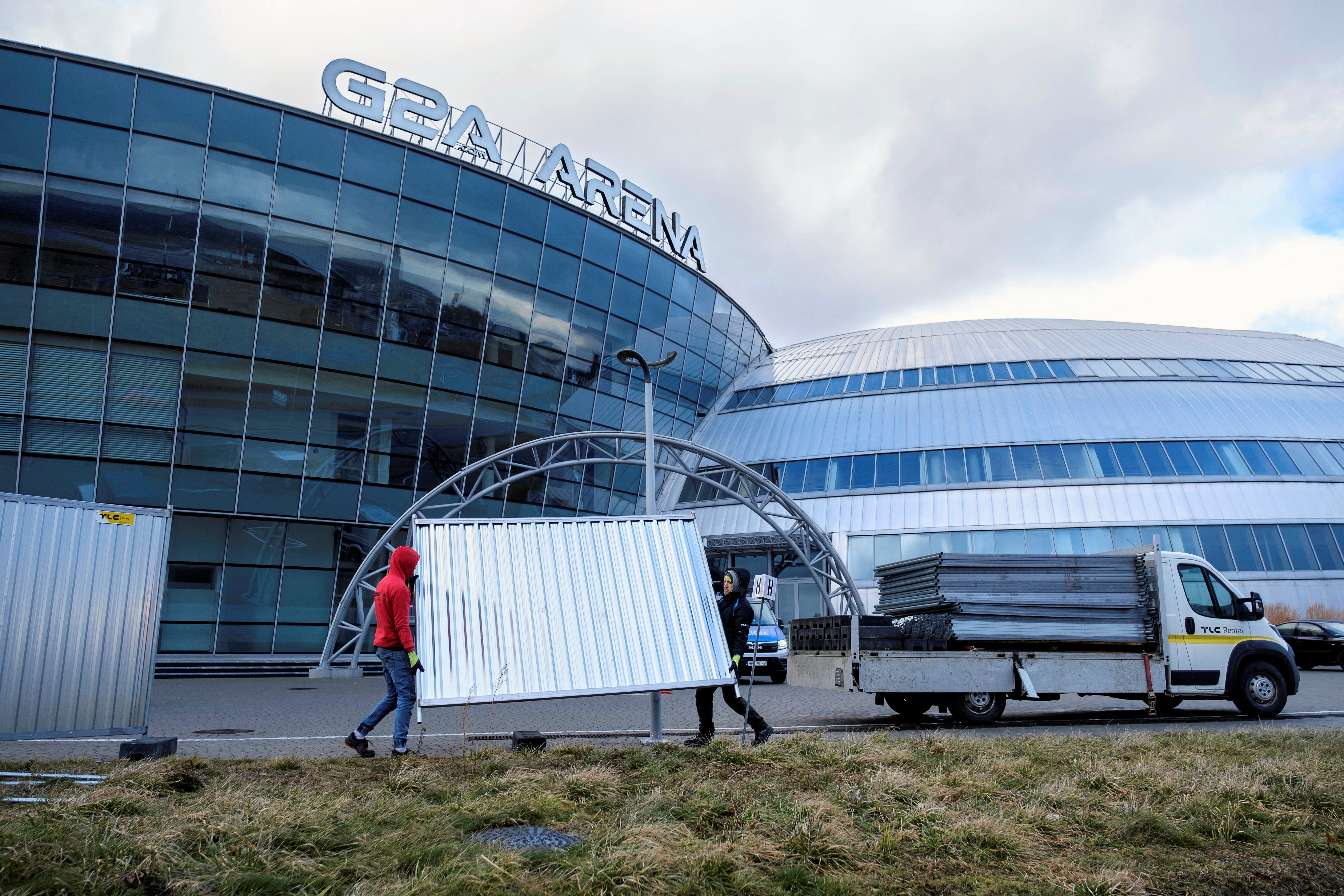 Workers set up metal barriers around the G2A Arena in Jasionka near Rzeszow