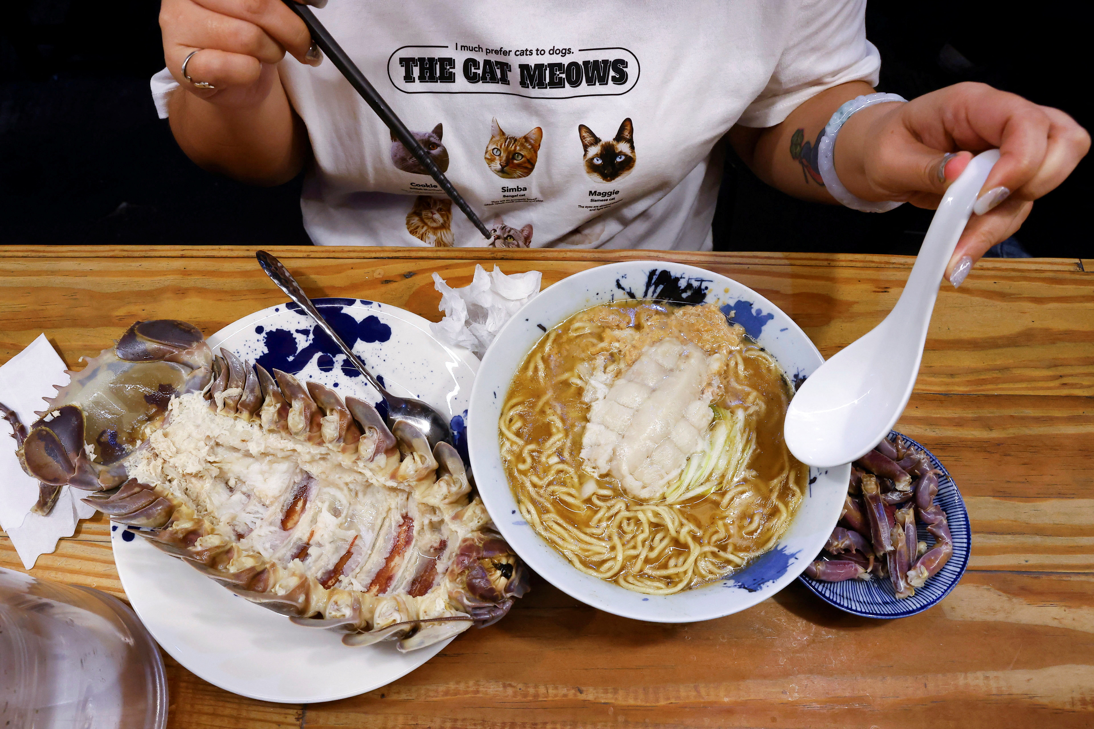 Digell Huang, 34, one of the two reserved customers tries the giant isopod ramen in Taipei