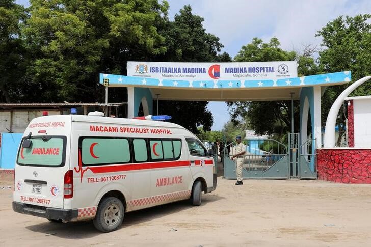 An ambulance carrying wounded from a suicide bombing attack at a military base arrives at the Madina Hospital in Mogadishu