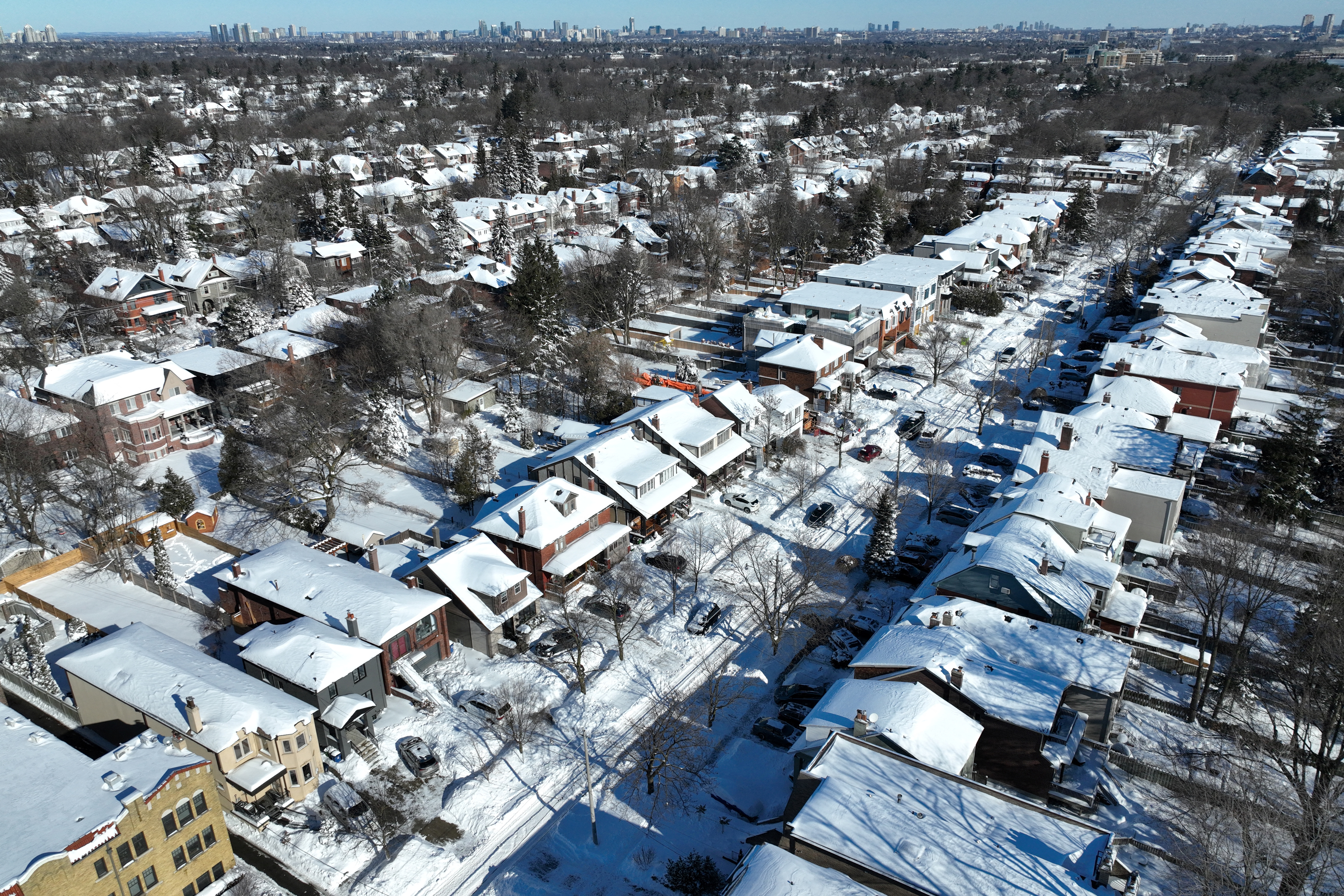A residential neighborhood is covered in snow, in Toronto