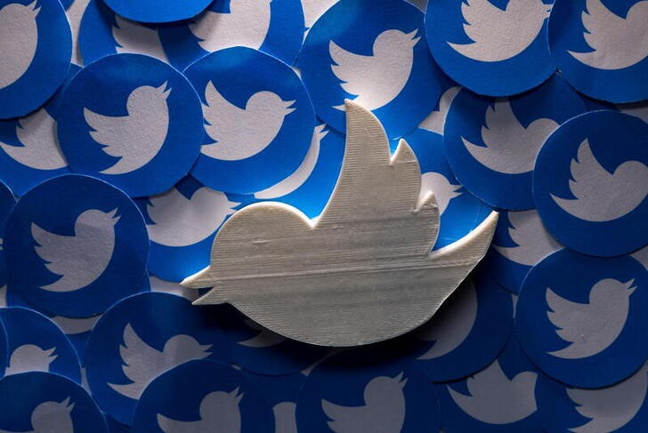 Illustration shows printed Twitter logos