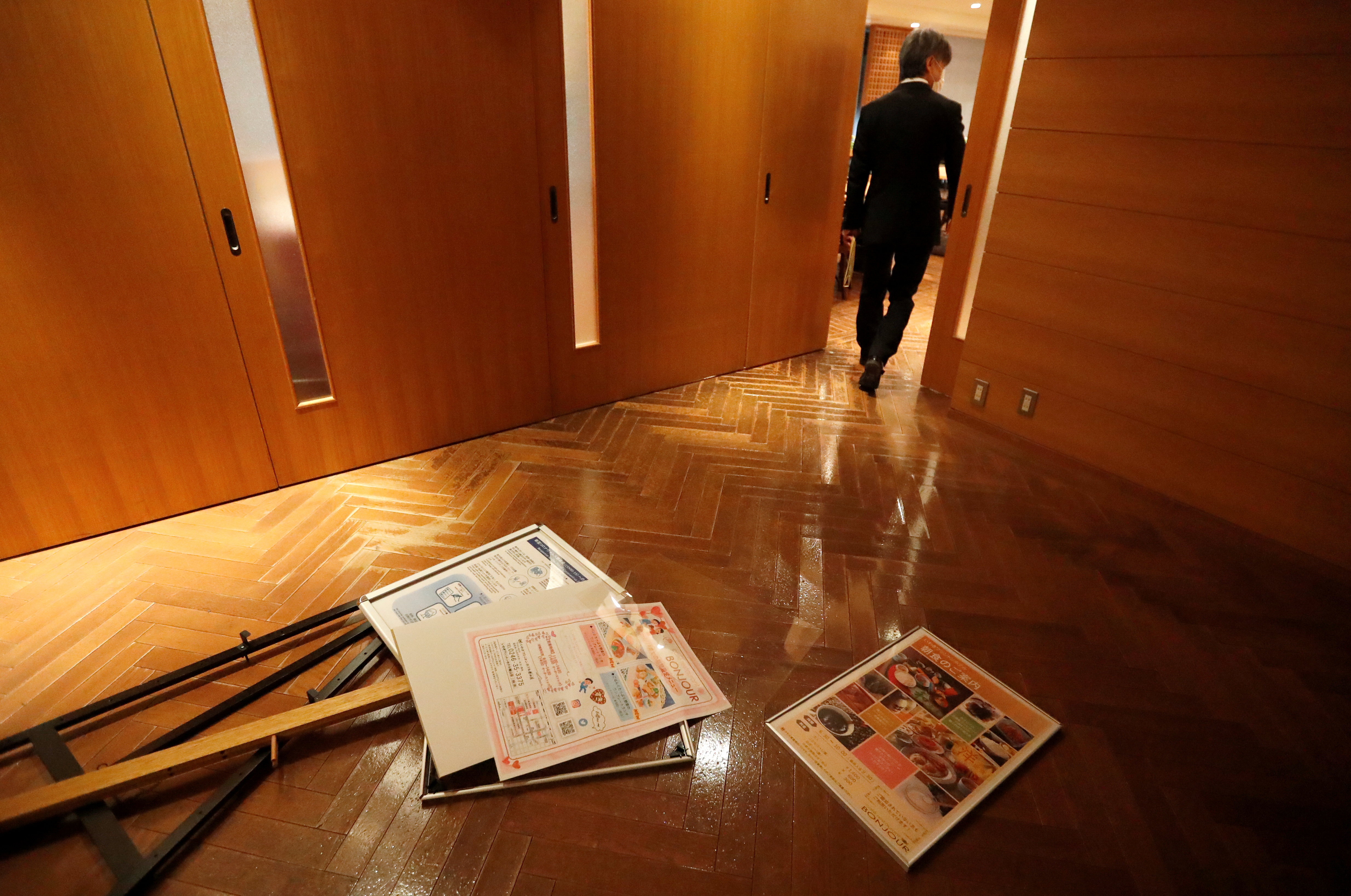 Posters lie on the floor after they fell from the walls of a hotel following a strong earthquake in Iwaki, Fukushima prefecture, Japan February 13, 2021.  REUTERS/Issei Kato
