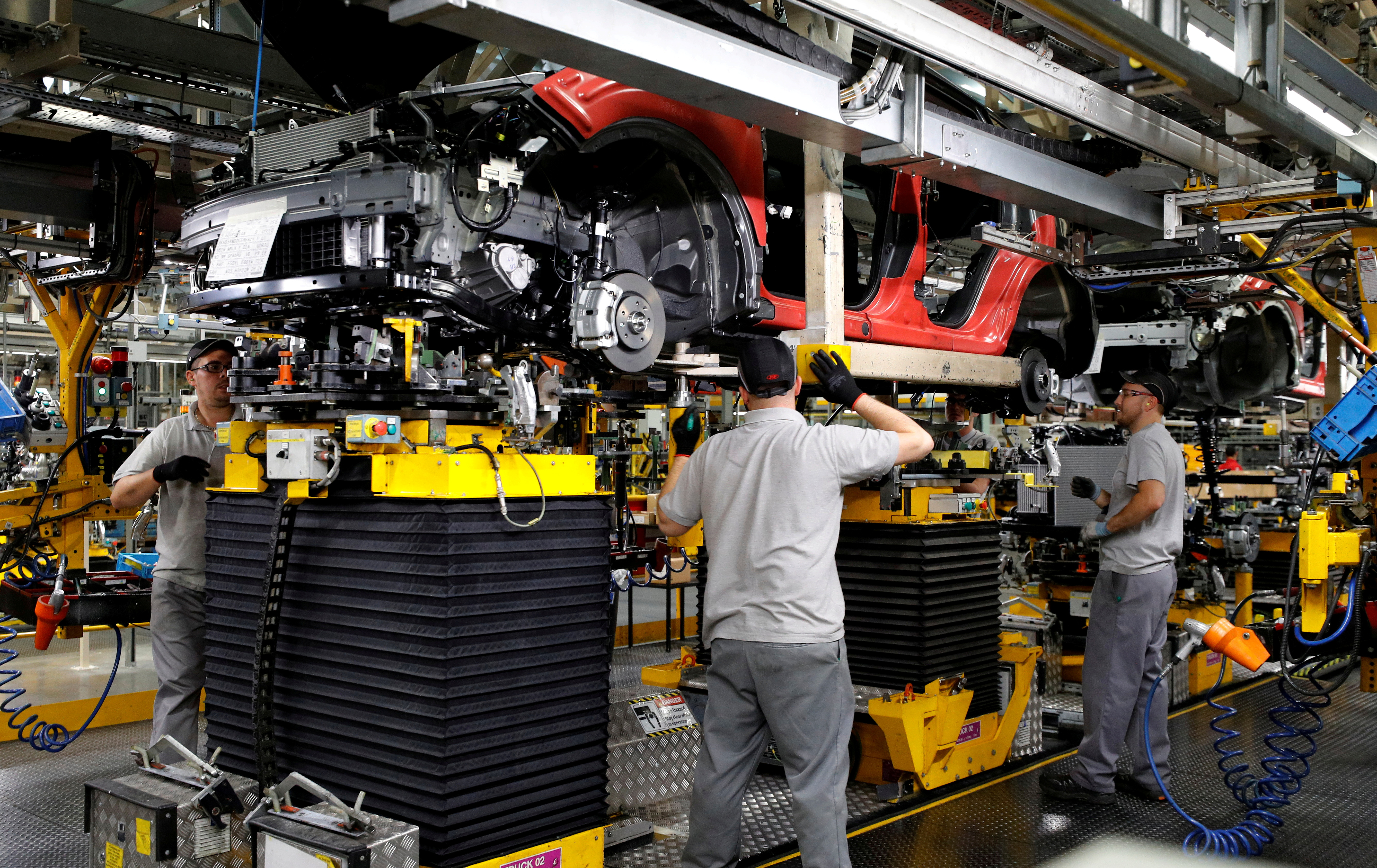 Workers are seen on the production line at Nissan's car plant in Sunderland, Britain
